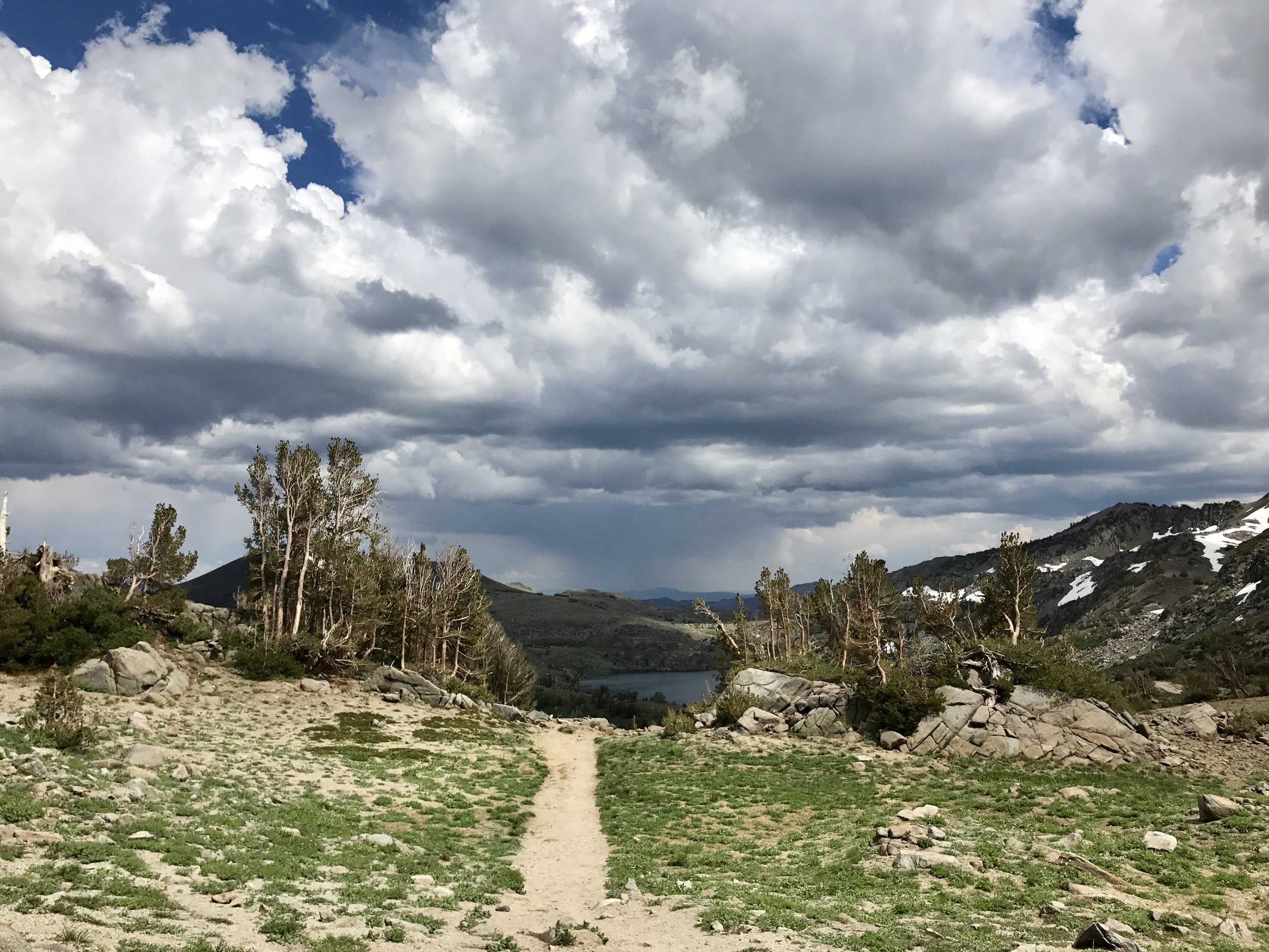   Heading back on the trail with storm clouds looming in the background, heading our way. We almost outran them…  