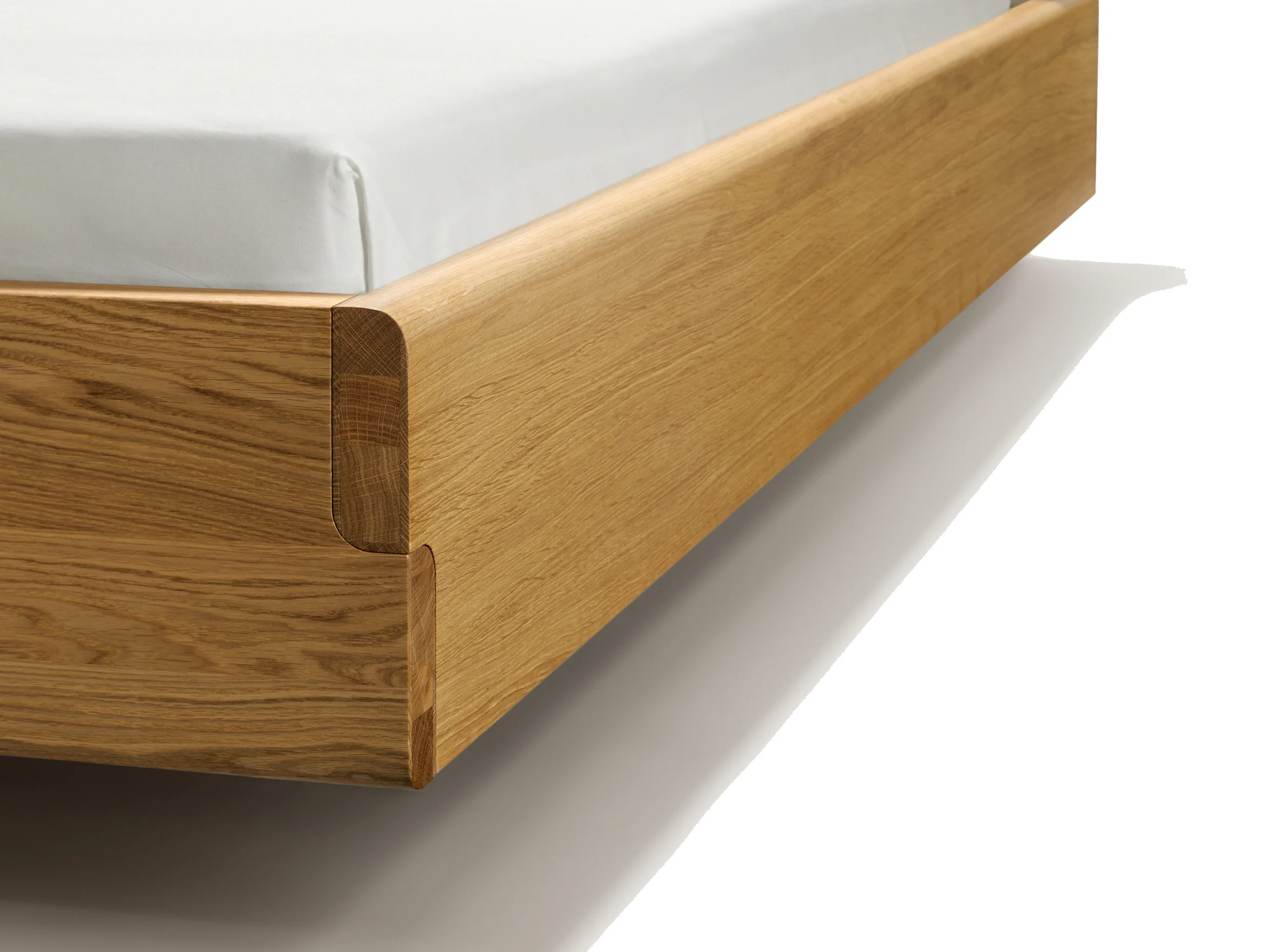 NOX bed The 3.9 cm thick natural wood bed sides with their S-shaped edge are characteristic of the nox bed. At the corners, the visible wood connections linking the bed sides combine to form an elegant S-line. Recessed foot panels let the nox bed appear to float. The bed's cleverly crafted, metal-free connections are exceedingly robust and easy to dismantle when moving to a new home. The nox headboard is available in two versions – in natural wood or upholstered with leather. The elegant lines of the bed sides are continued in the headboard. The nox leather bed head with contrasting decorative stitching can be used either as a head rest or a back support, for relaxed reading or sitting up straight. Text/Photos/Producer: TEAM 7 Design: Jacob Strobel 2010
