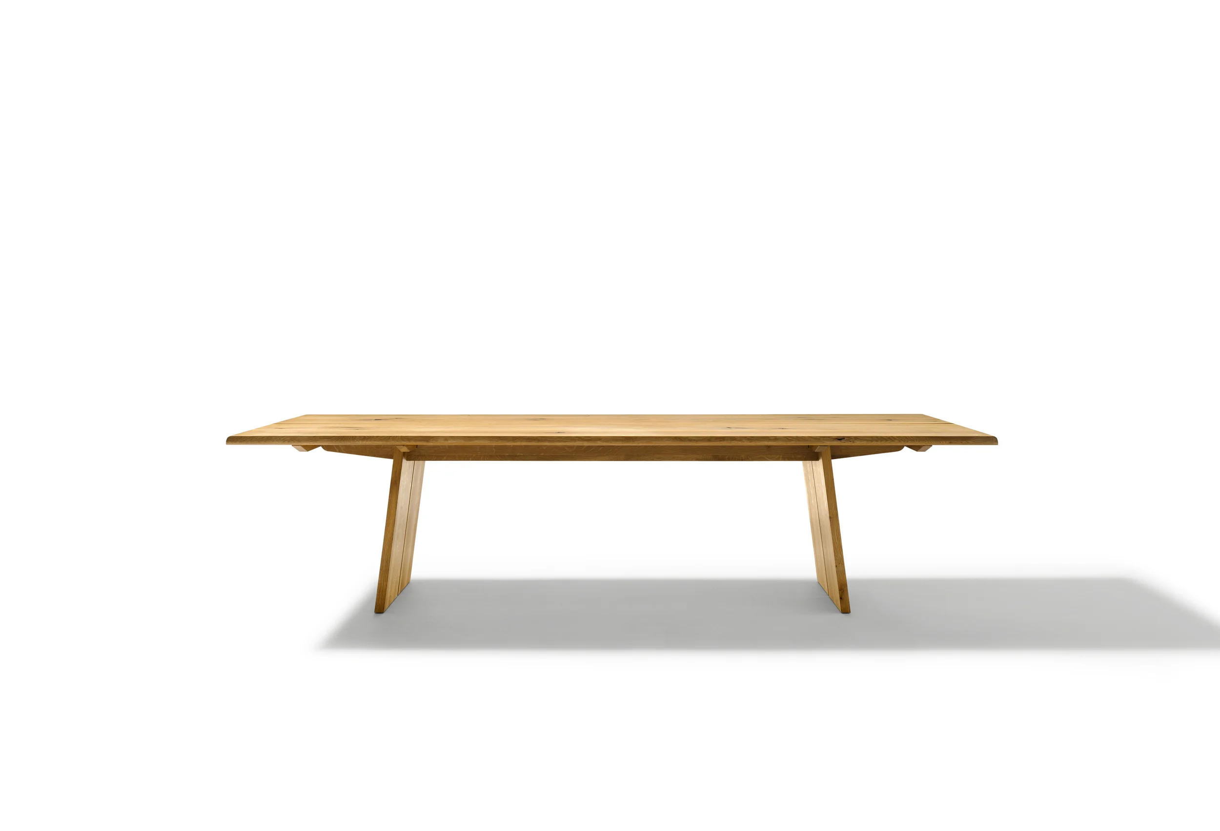 NOX table A masterpiece of nature is embodied in the nox table. Made from 100% natural wood, the nox table stands out above all through its 3.8 cm thick and up to 3 metre long tabletop. The robust oak and walnut tabletops are additionally available with wild natural look. Such natural features as knots and striking grain patterns are characteristic of this particular look. Perfectly crafted details, such as the gently rounded S-shaped edges of the corners, underline the table's first-class quality. The longitudinal join in the centre of the table can optionally be covered with a metal pilaster strip. Text/Photos/Producer: TEAM 7 Design: Jacob Strobel 2010