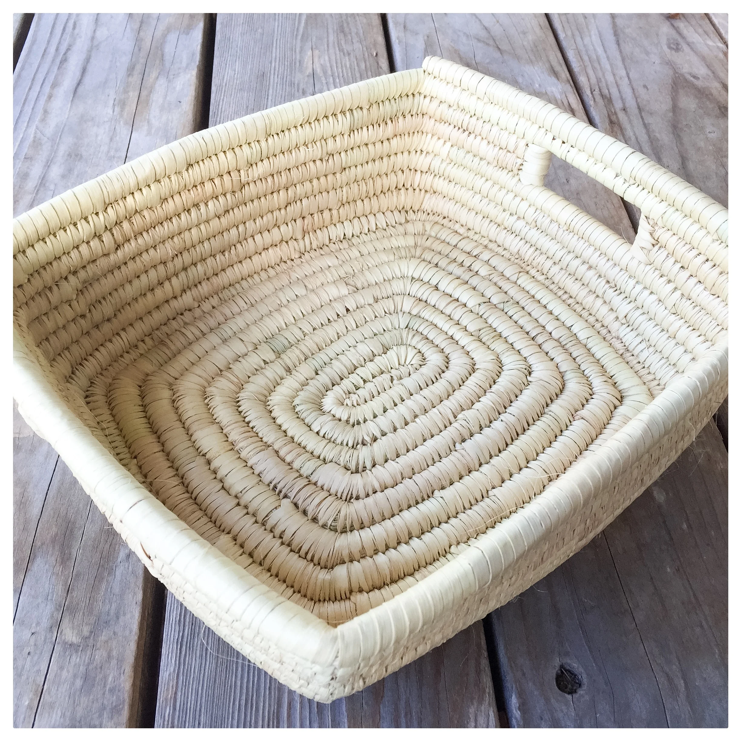 Made in Tanzania, this basket is both functional and decorative. It measures 11" x 12" and is made from woven grass. 