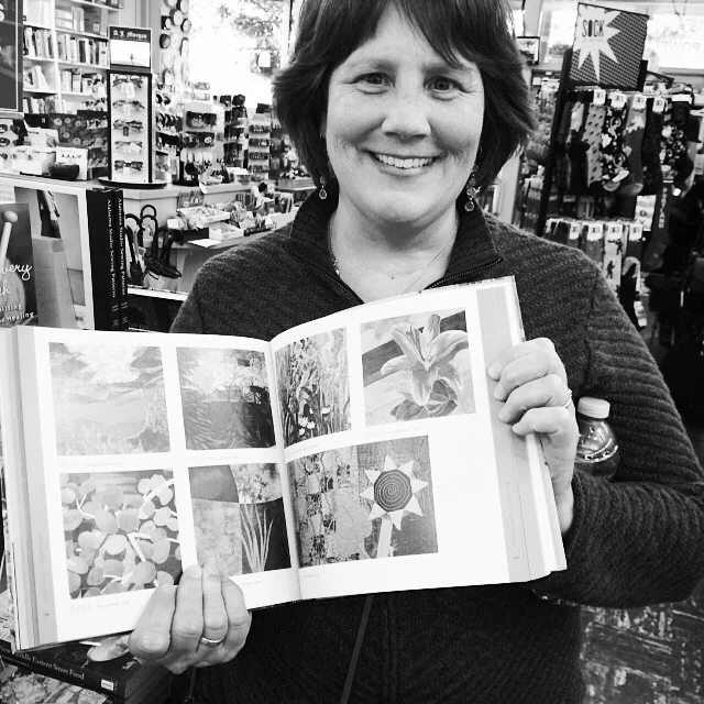 My artwork (bottom right) in the book, 1000 Quilt Inspirations, at Powell's on Hawthorne.