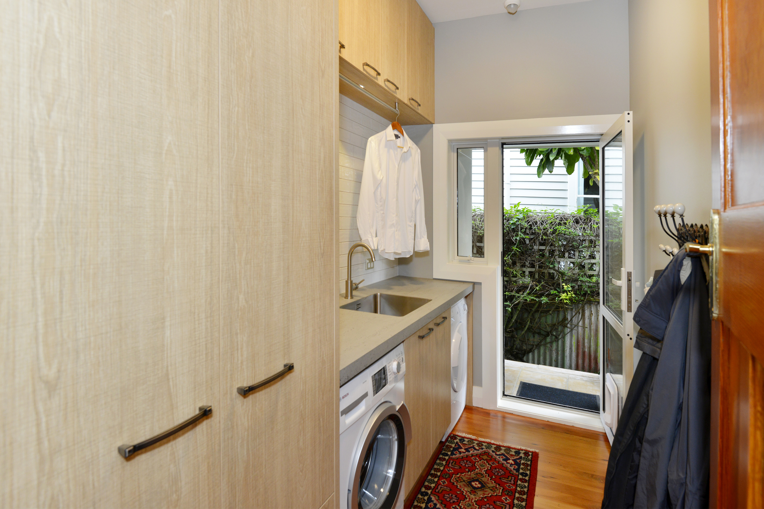 Clothes hanger over the laundry bench