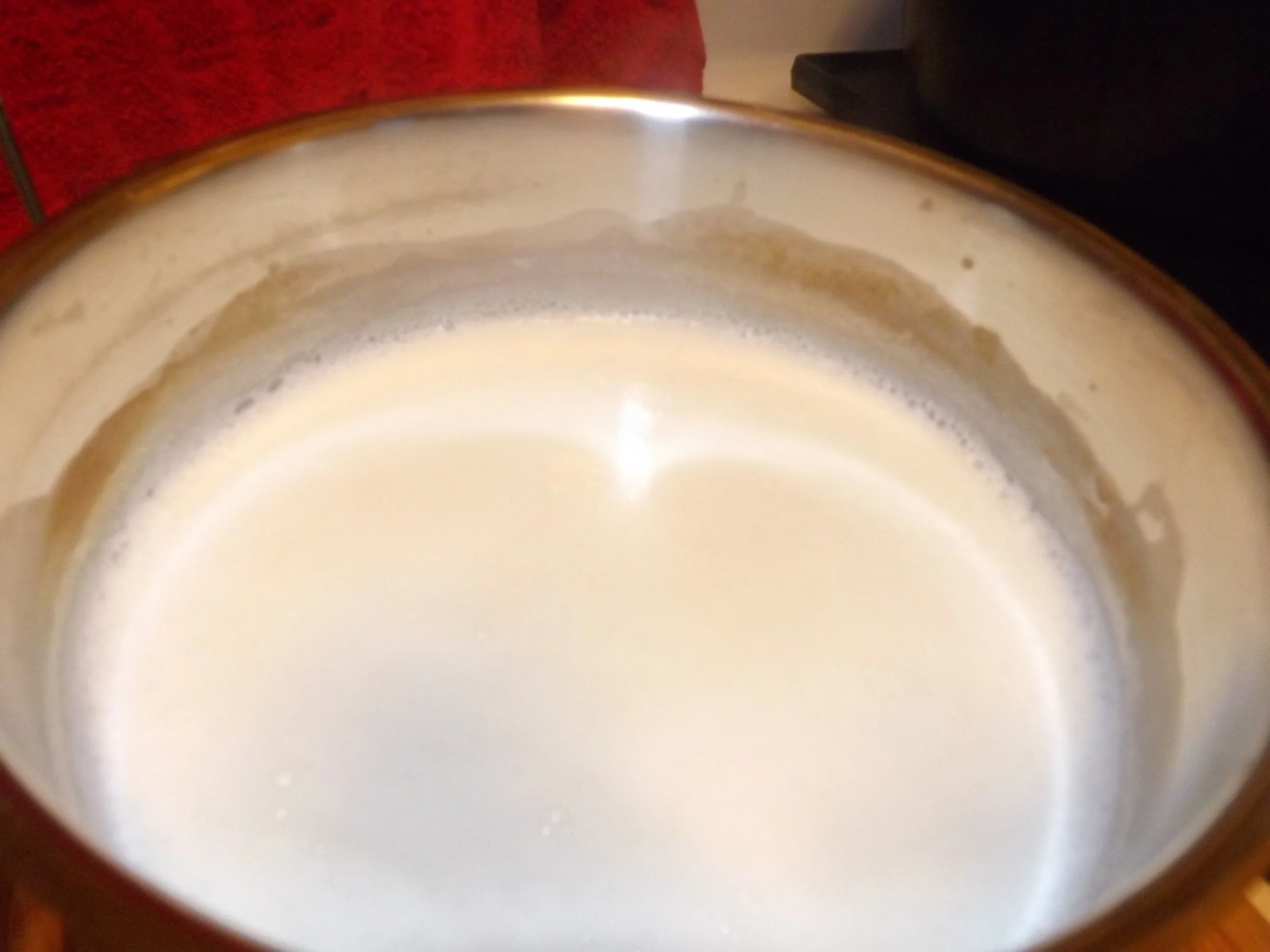 Once the milk reaches 180 degrees, it's frothy and little bubbles start to from around the edge of the pan. Stir occaisionally so as not to scorch the bottom of your pan. Yuck. 