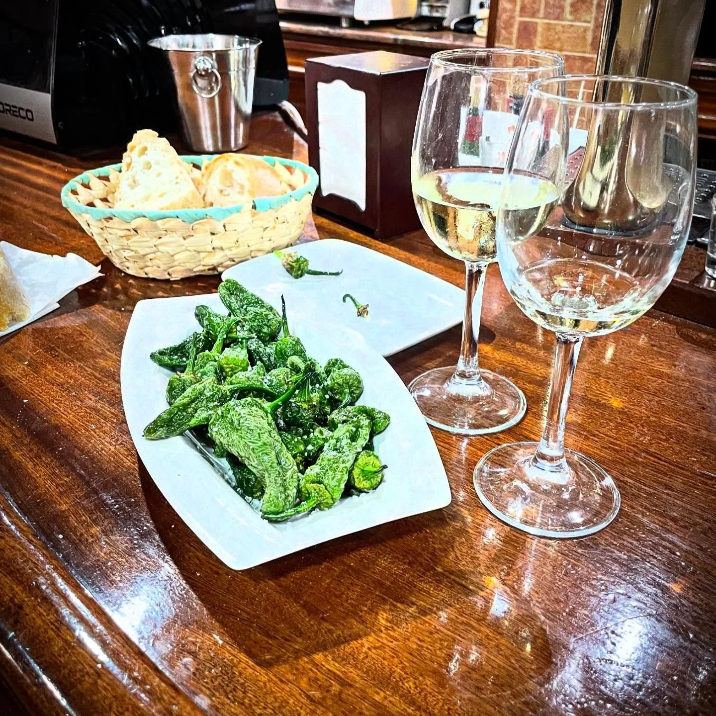 Morning Snack. Quick stop on an old town wander to share a plate of Padron peppers and a glass of Godello. Simple excellence. #wine #tapas #raciones #food #foodie #Spainfood #NorthernSpain #customtours #privatetour