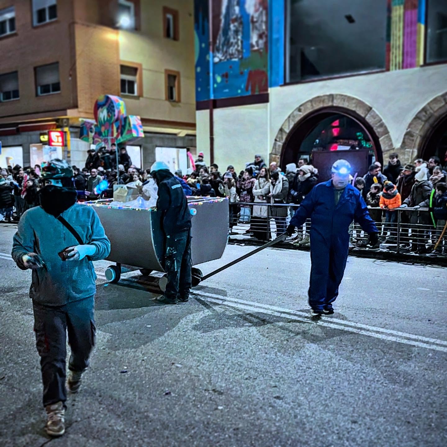 Coal for the Naughty. Tonight is when the Three kings of Orient come to town and will leave gifts for kids to open tomorrow morning.  Been good? Get gifts. Been bad? You get coal.  Here are the miners giving out rock candy coal as a reminder to be go