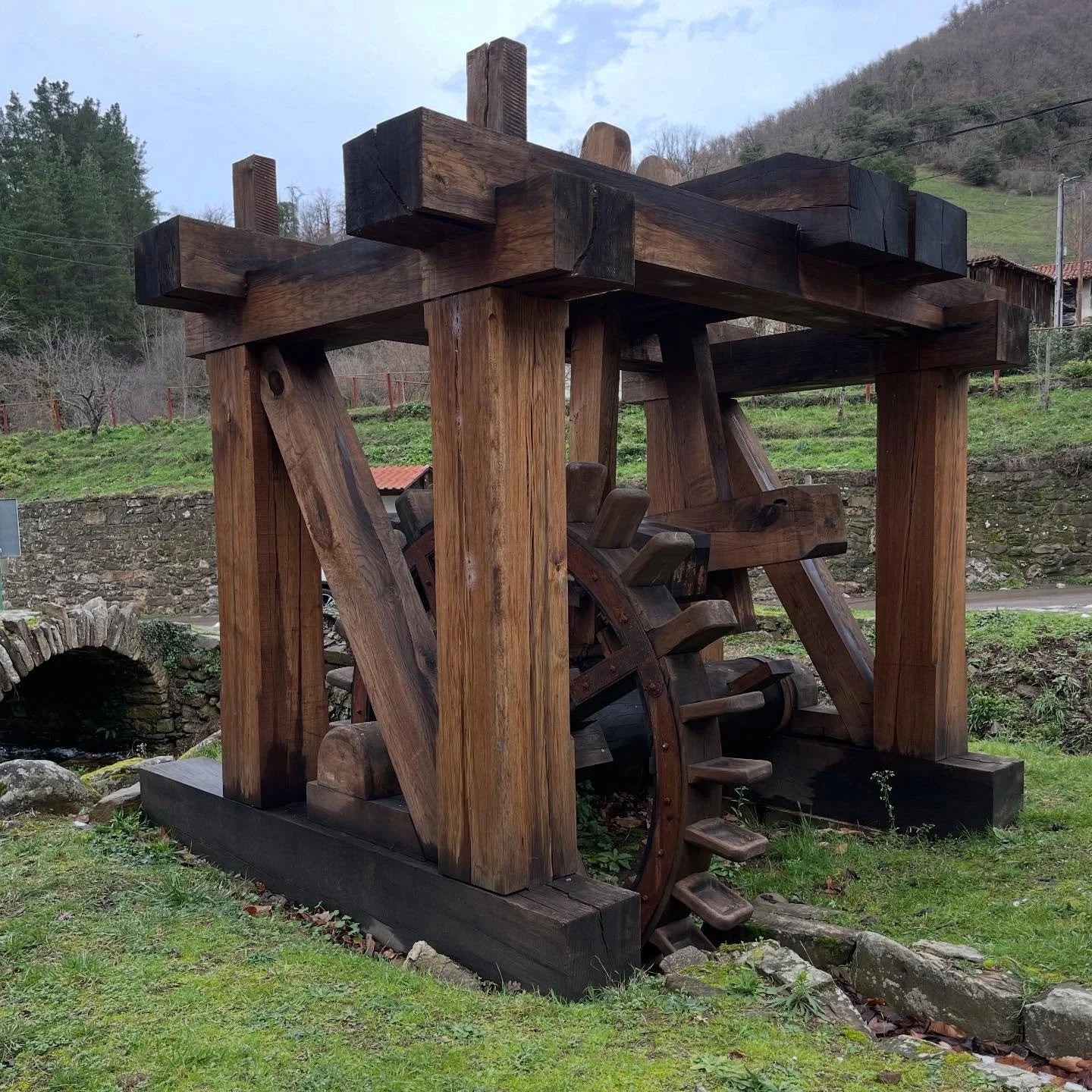 Felt Hammer. Ingenious water powered device. A water powered wheel, rotates an axel with levers that trip hammers to strike a log bench where wool was placed in opposing vertical/horizontal layers to smash it together to form thicker felt using press