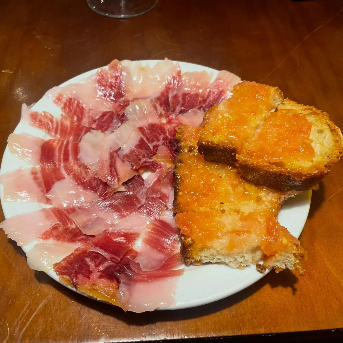 Simple Pleasure.  Great bread, a little grated tomato, and hand cut Iberian acorn fed ham. So simple, spectacularly good. A perfect light dinner. #Spainfood #Spainfoodie #foodtours #Spaintour #customtours