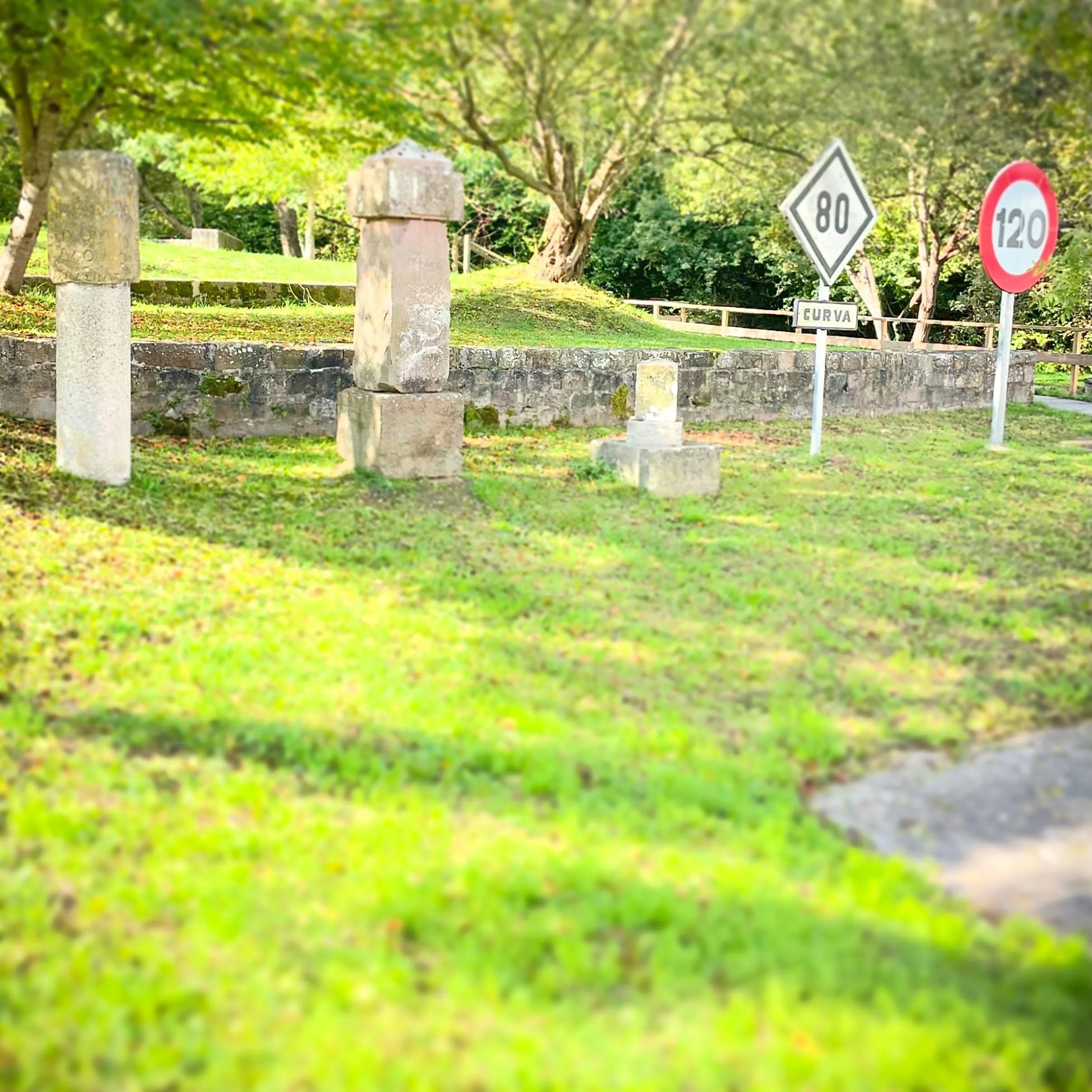 Signs of the Times.  5 different signs for 5 different eras of the same route.  L to R.  A Roman milliarium (1st c.), a Royal road marker (18th c.), Spanish National Road marker (20th c.), railroad speed limit sign (19th c.) and Spanish interstate hi