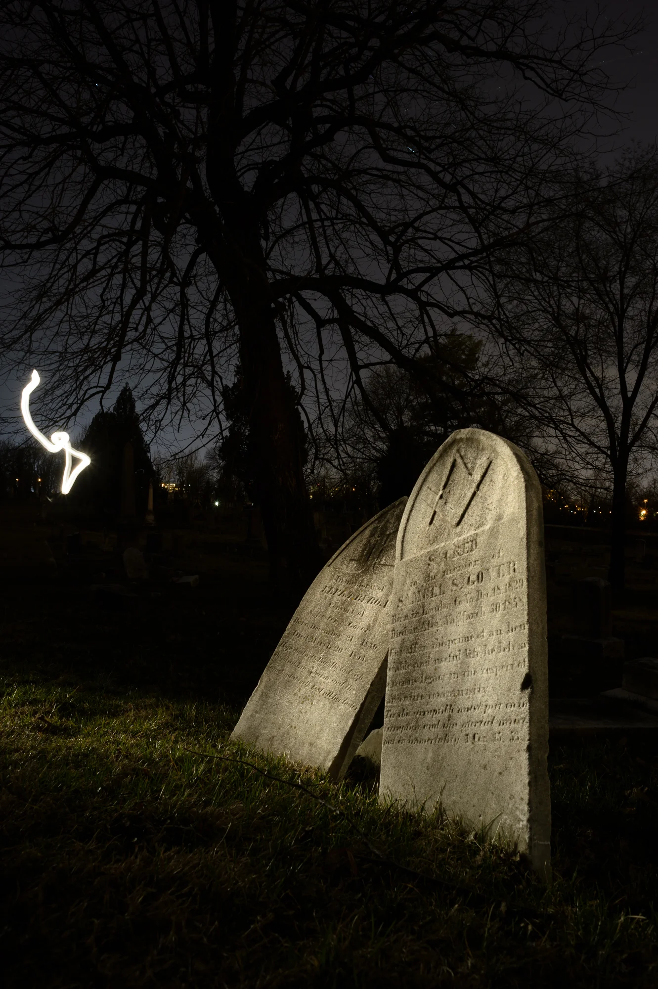 In this image, while light painting the gravestones, my flashlight slipped out from behind my body and the camera was able to “see” it.
