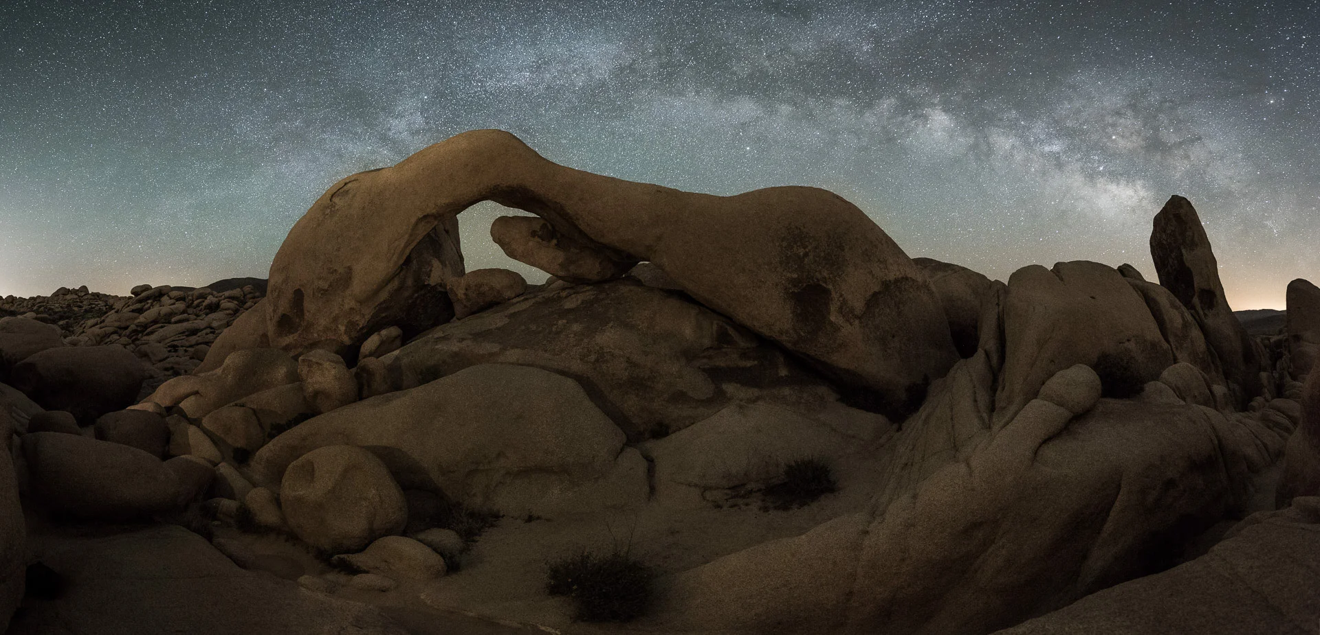 A great example of low-level lighting: In Joshua Tree National Park, Arch Rock, at 30 feet high, was light-painted by just three battery-operated votive candles. Illumination barely visible to the naked eye even from close-up. Six stitched frames shot with a Nikon D750 and a Tamron 15-30mm f/2.8 lens at 15mm Photo © 2017 Lance Keimig.