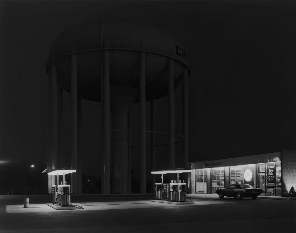 George Tice, "Petit’s Mobil Station, Cherry Hill, NJ, 1974." Tice’s best-known image was a 2-minute exposure on 8x10 film that took 10 minutes to expose because the photographer had to repeatedly cover his lens due to cars passing through the scene.