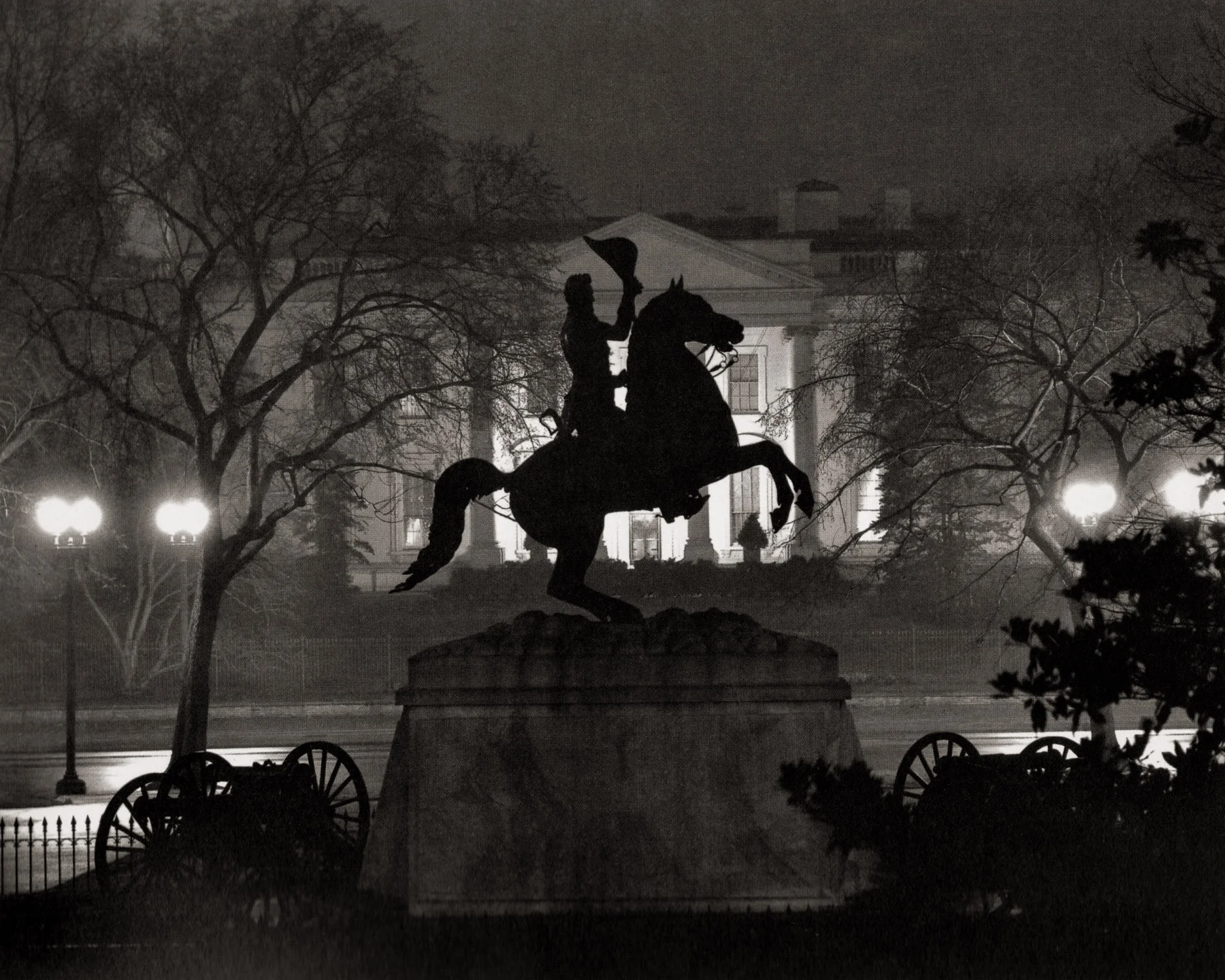 “Lafayette Square.” A silhouetted sculpture of Andrew Jackson on a rearing horse opposite the North Portico of the White House. Wentzel used an exposure that kept the sculpture in shadow, but preserved the detail of the illuminated White House. As was typical of this series, Wentzel chose to photograph on a wet and foggy night, a strategy that he no doubt observed in the night work of Brassai, and perhaps in Stieglitz’s as well.