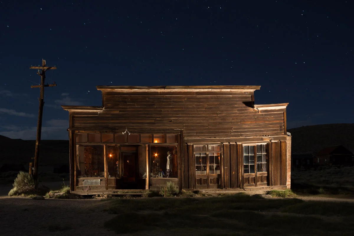 The last-quarter moon was just rising behind camera to the right. Lit with a Surefire P9 incandescent flashlight from the left and right sides at oblique angles. It was a challenge to light both sides of this large building in 30 seconds, but it was freezing cold so I ran from side to side to do the lighting to keep warm. You can see that I overlit the right side and the underside of the top of the building. The background was too dark. 30 seconds, f/8, ISO 800. Canon 6D and Nikkor 28mm f/3.5 PC lens.