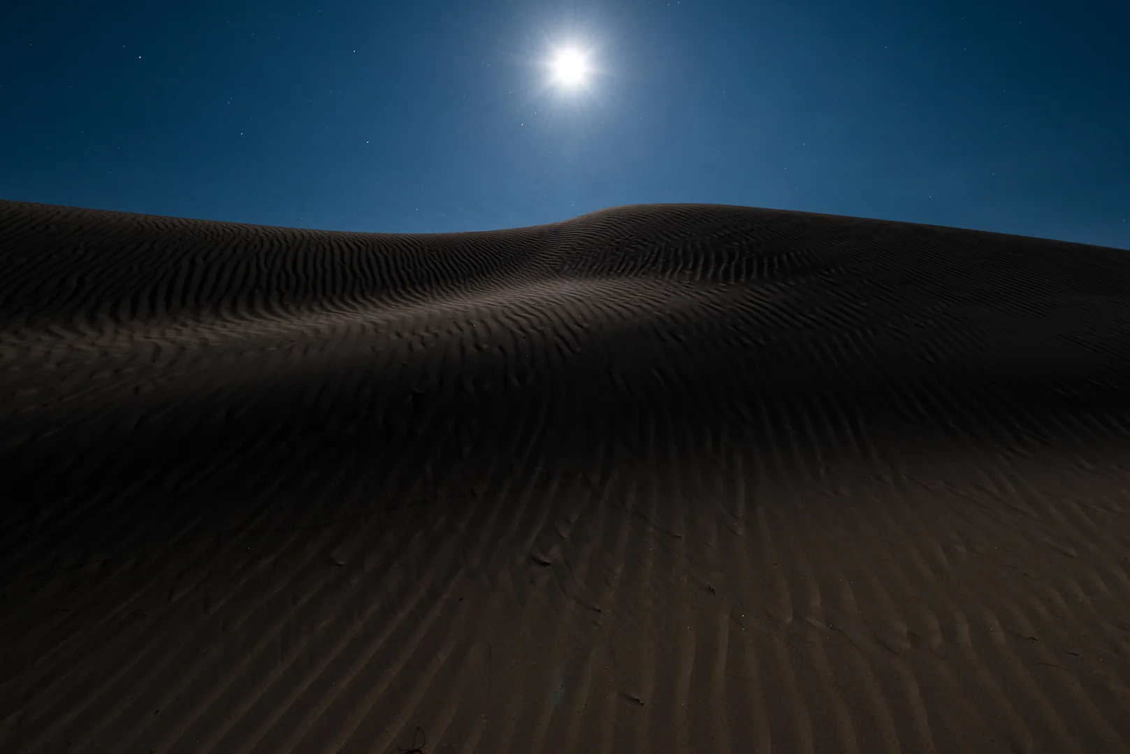 The moon rising over Mesquite Flat Dunes, Death Valley National Park. Nikon D750 , Tamron 15-30mm f/2.8 . Dunes light painted with a Coast HP5R flashlight. © 2016 Lance Keimig.