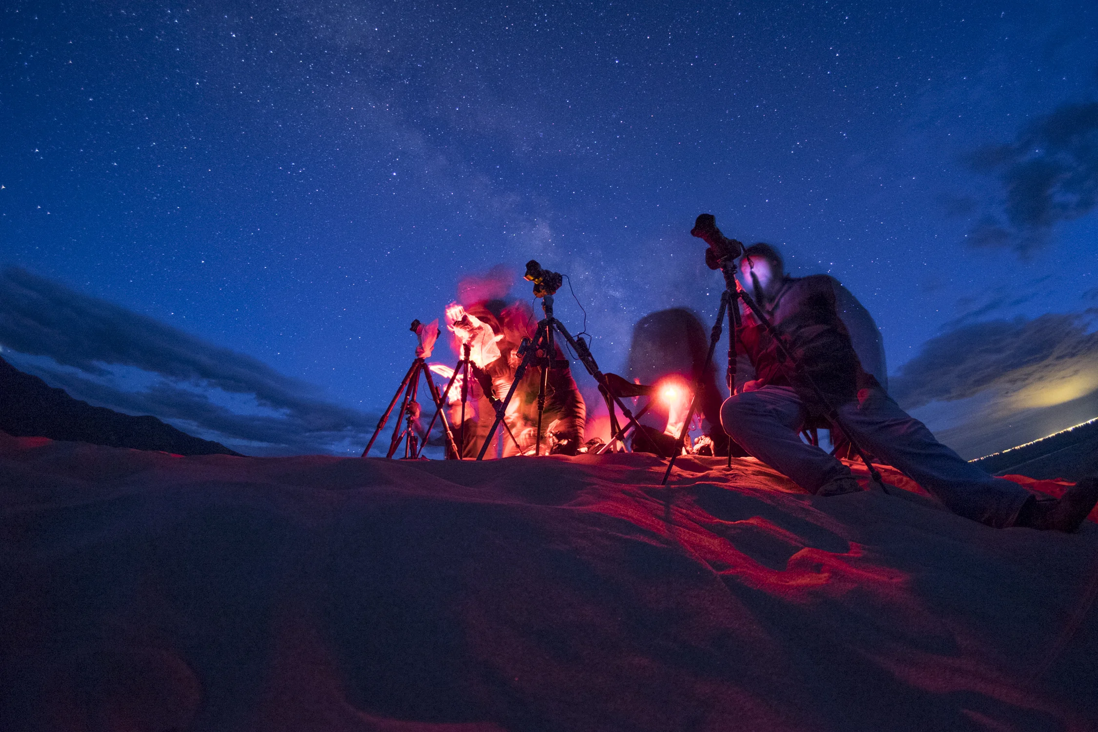 Notice how the red light “bleeds” into the area surrounding these photographers at Great Sand Dunes National Park. Photo by Matt Hill.