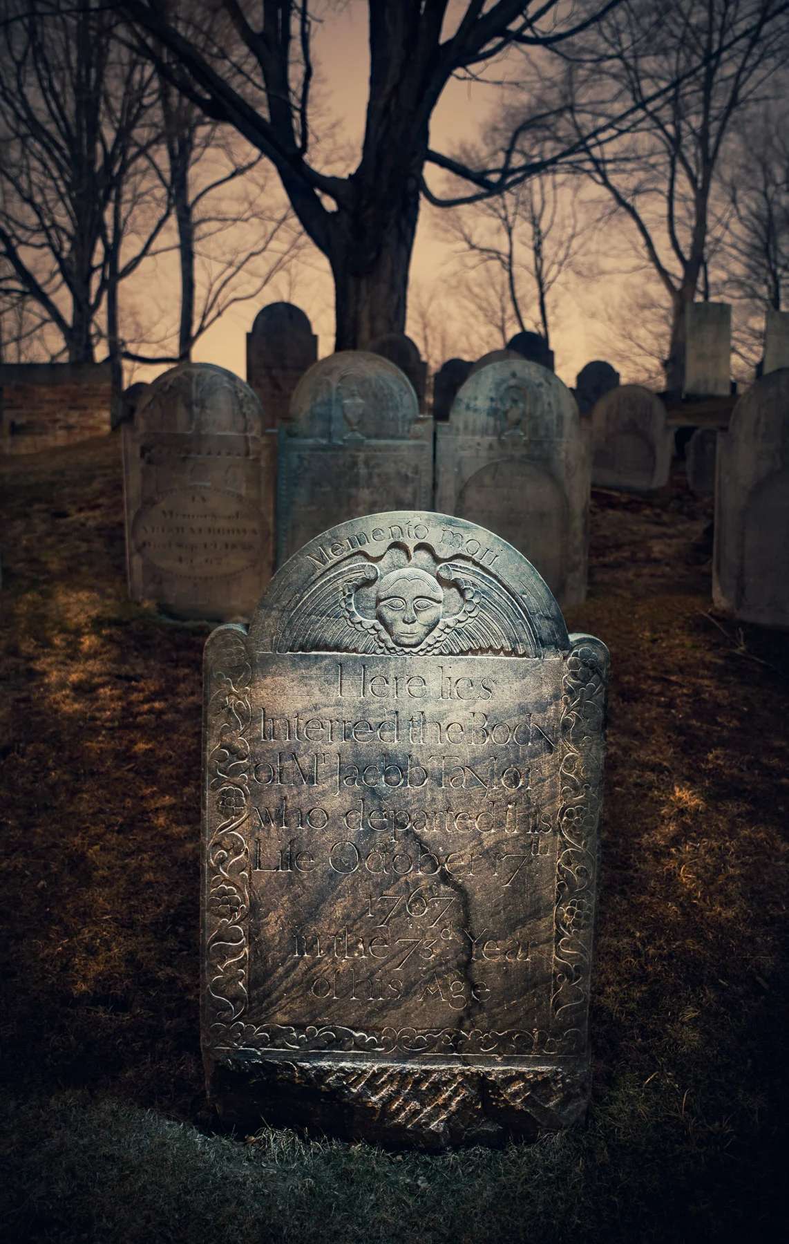 Jacob Taylor has resided at Sleepy Hollow in Concord, Massachusetts, since 1767. The image was made in 2010 with a Surefire G2 flashlight from slightly above the stone, flagged with black mat board so the camera didn’t see the light. The three headstones in the middleground were lit with the same light source, but indirectly. I bounced the light off of a 12-inch Wescott reflector from behind the central stone. The shallow depth of field and strong vignetting also help to isolate the primary subject. Canon 5D Mark II, Canon 50mm f/1.4 lens. 3 minutes, f/4, 100 ISO.