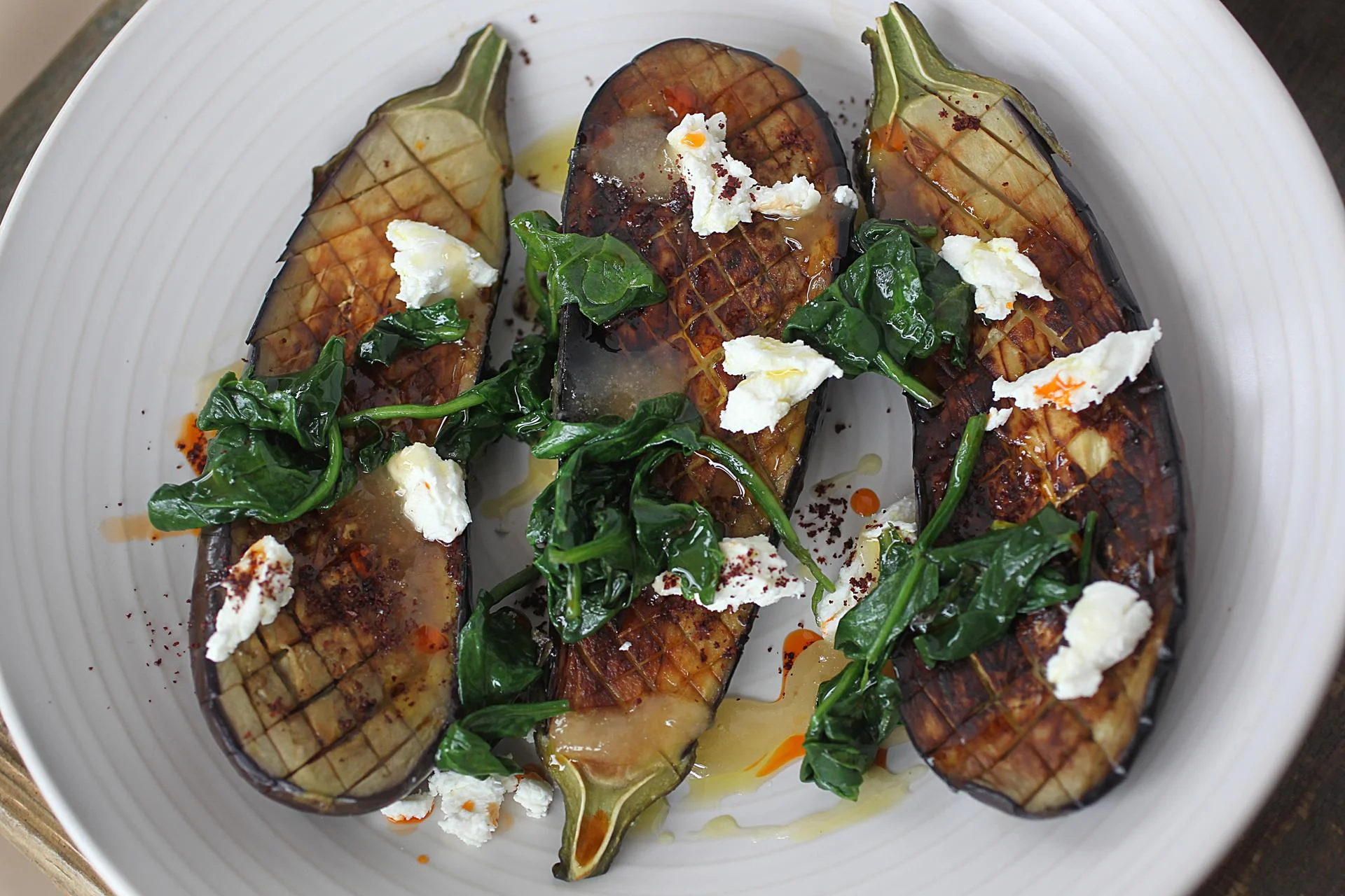 In Concord, Saltbox Kitchen’s roasted eggplant with braised spinach, goat cheese, honey, and sumac. Photo Credit: Suzanne Kreiter/Boston Globe Staff