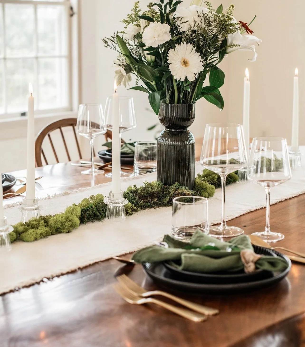 Elegant dining table setup with green and white centerpiece