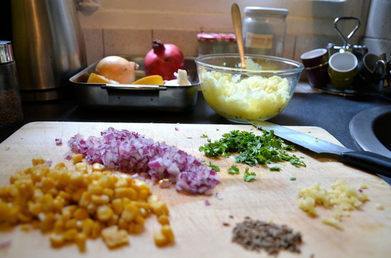 -finely dice your onion, coriander, and garlic to create your filling. peel your potatoes and mach in a bowl and add salt