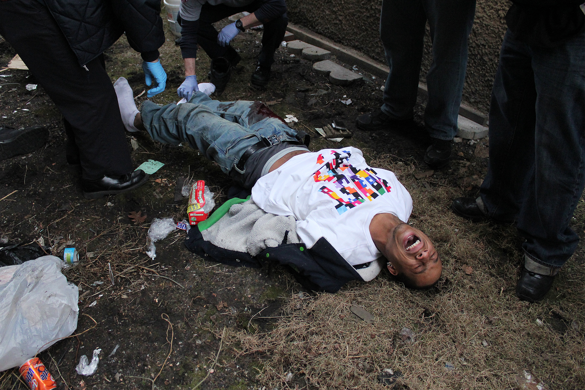 Paramedics examine the body of an injured man who was shot in the leg in the Woodlawn neighborhood on Chicago’s south side. The neighborhood is known as one of the worst areas in the U.S. in terms of high rates of violent crime.