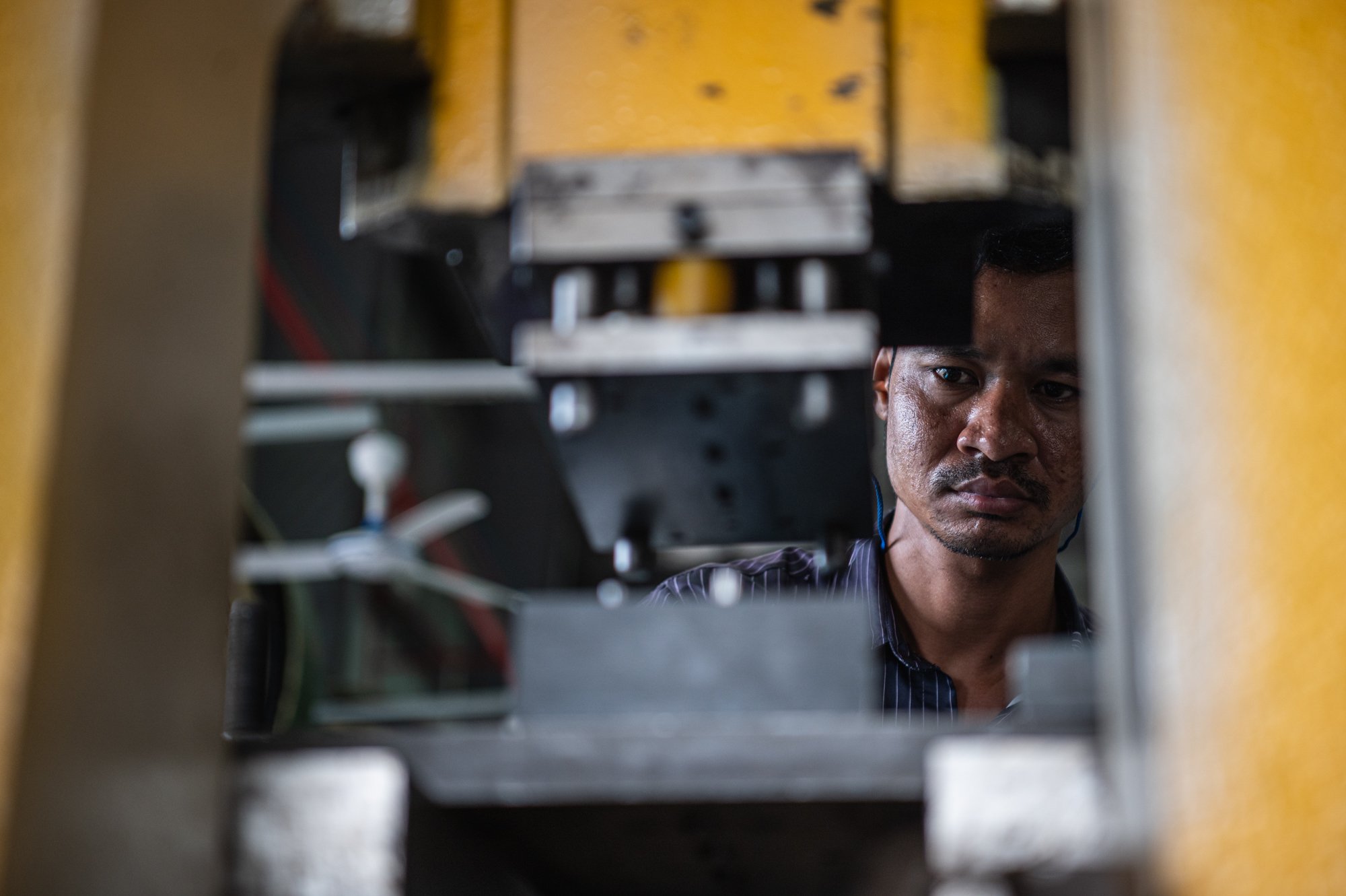  A worker stamps and processes kitchen tools and utensils at a Velong factory in GiGA Resources Special Economic Zone in Svay Rieng province in Cambodia. 
