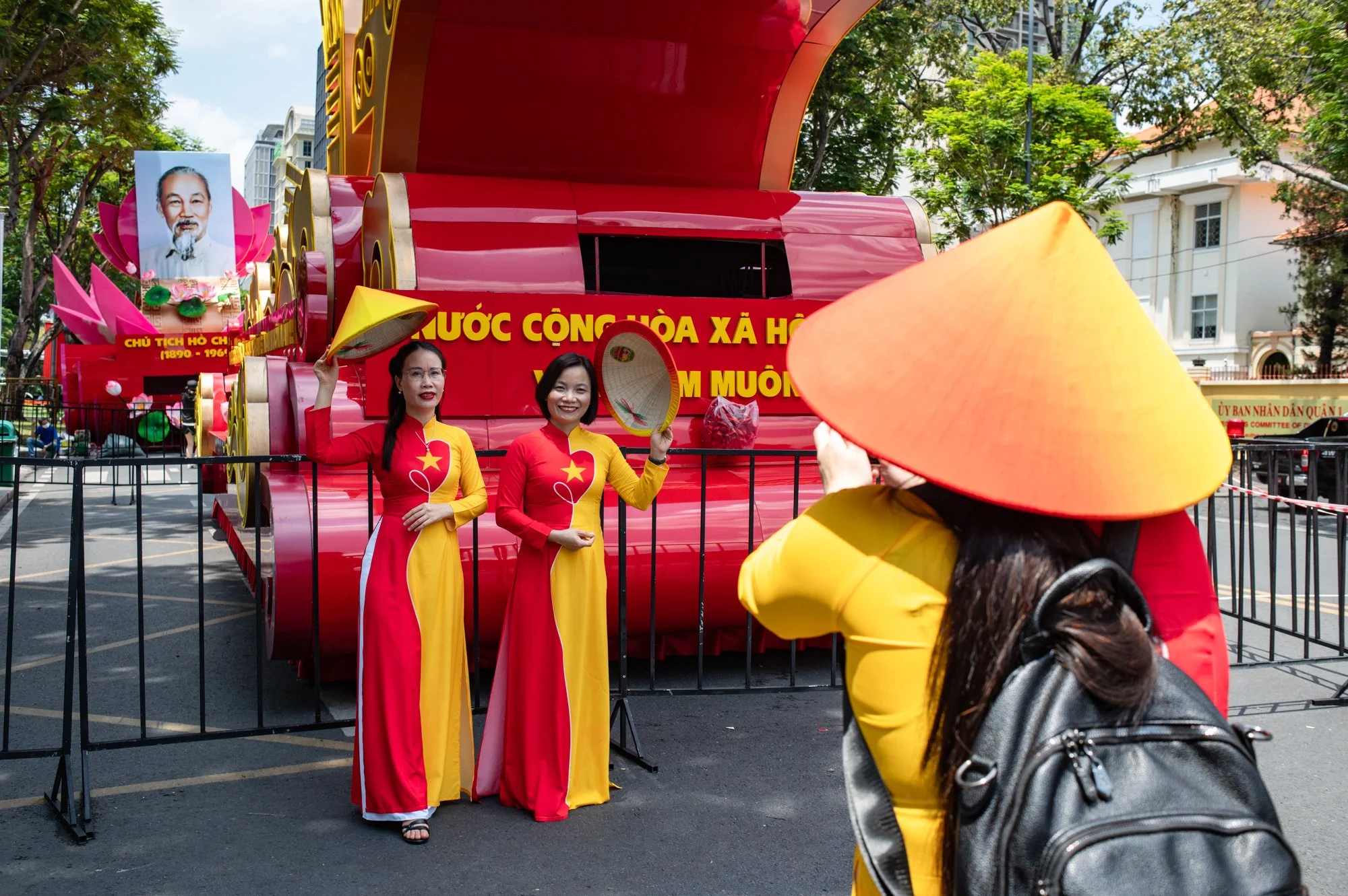  Women dressed in traditional Vietnamese dresses take photos in front of the parade floats decorated with portraits of Ho Chi Minh in the wake of celebrations dedicated the 50th anniversary of the end of the Vietnam War in Ho Chi Minh City, Vietnam. 