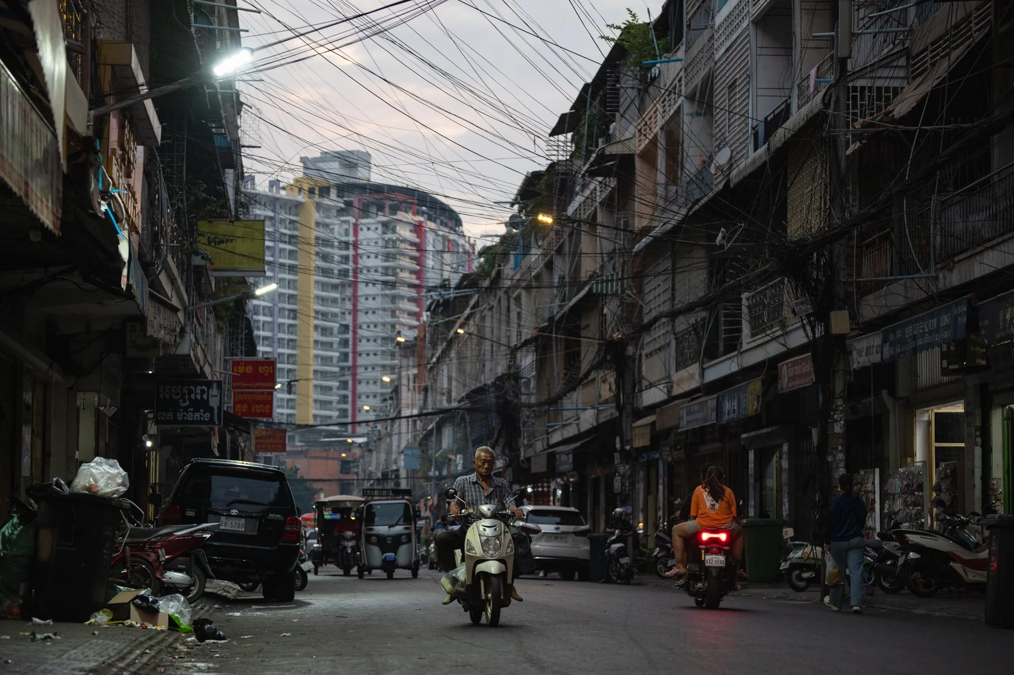  A man drives his motorbike at sunset in a historic part of town near Orussey Market in Phnom Penh, Cambodia. 