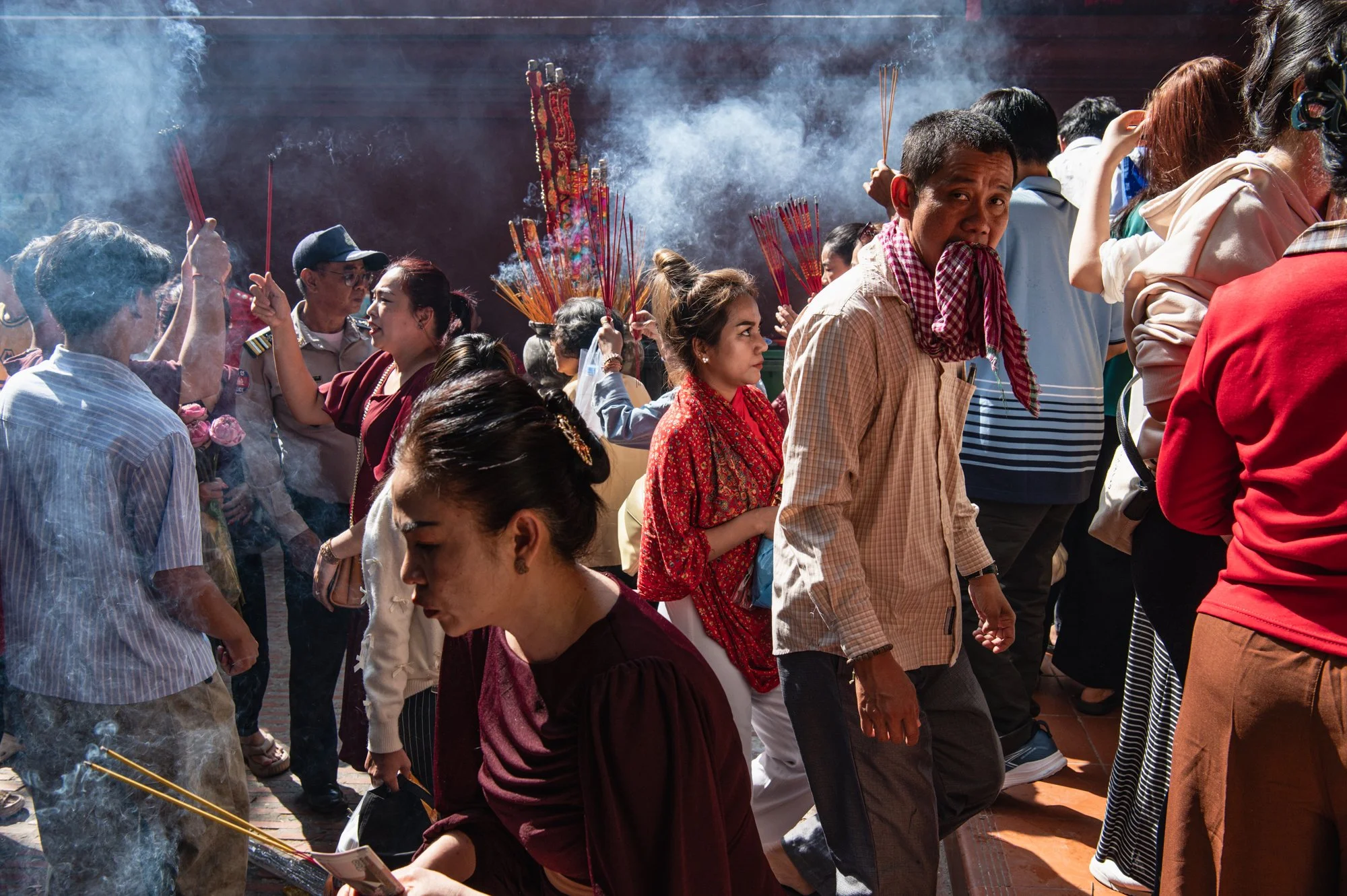  People burn incense during the celebration of Chinese Lunar New Year at Wat Phnom temple in Phnom Penh, Cambodia. 