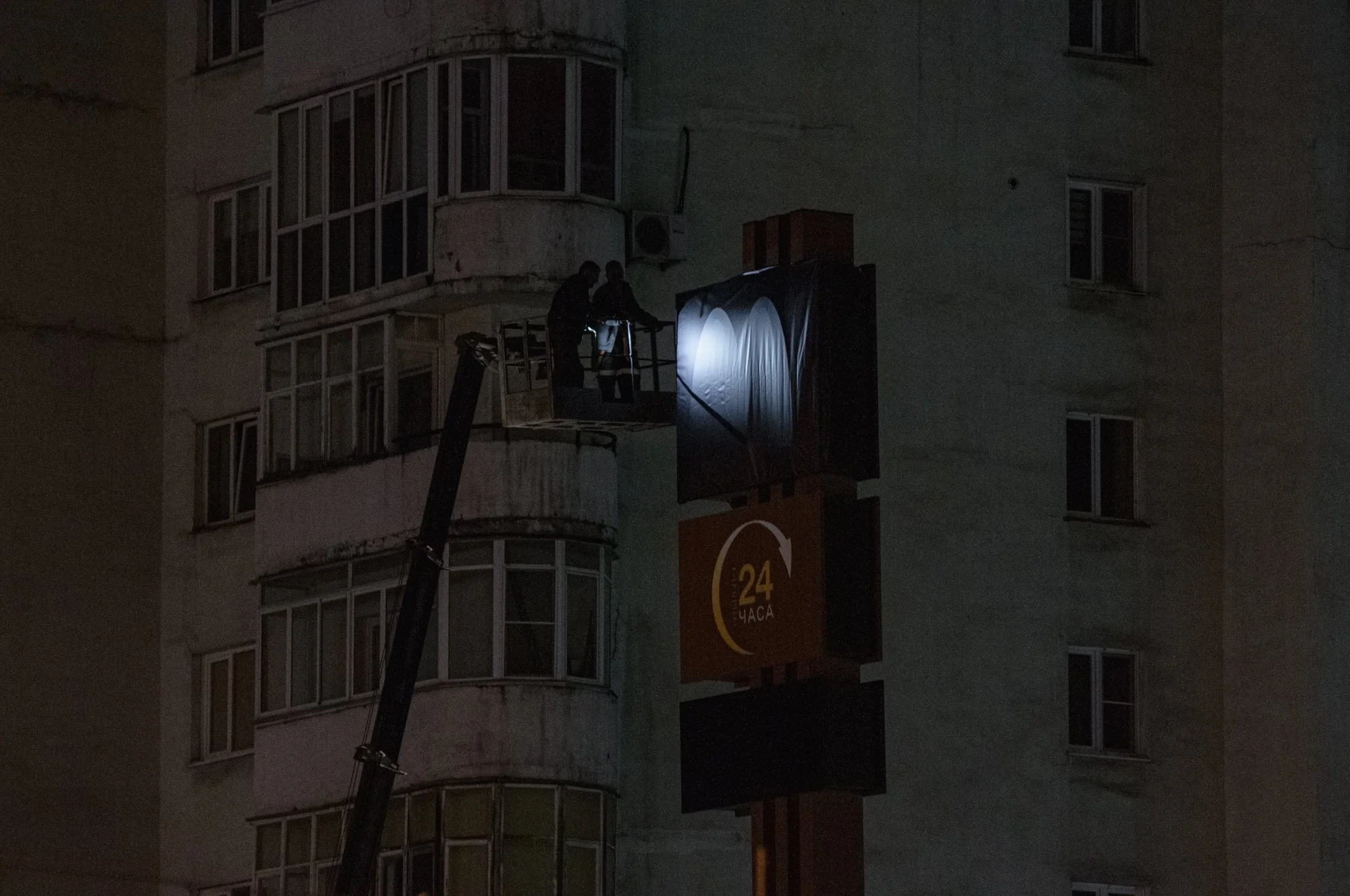 Workers cover up a sign on a McDonald's in Novokuznetsk after the company suspended operations in Russia in March, 2022 and sold all restaurants to a businessman from Siberia, who rebranded the chain and reopened the restaurants under the name ‘Vkusn