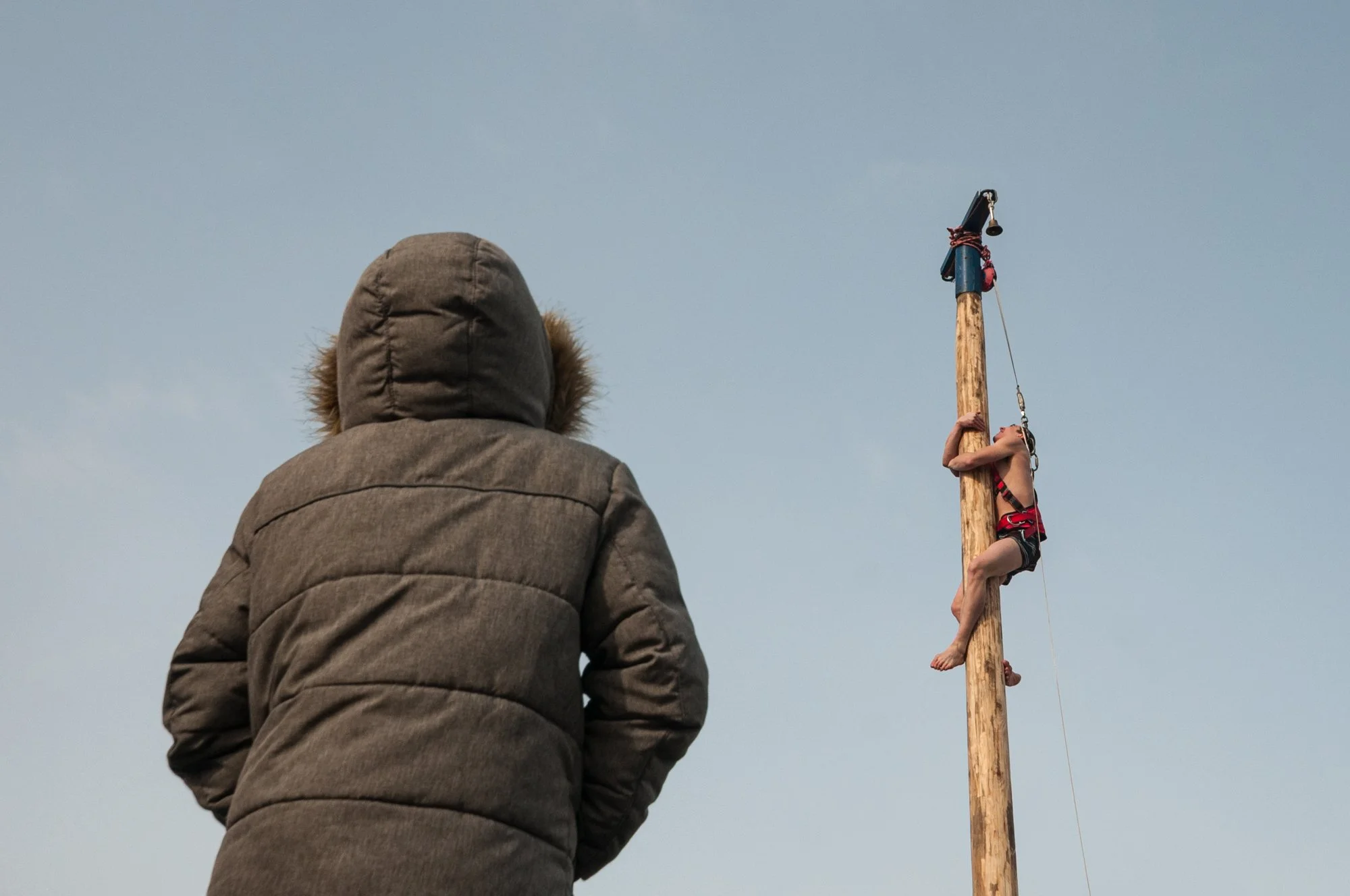 A man climbs a polished wooden pole to grab a prize at the top during the celebration of Maslenitsa in Novokuznetsk, Russia. Maslenitsa, also known as pancake week, is a traditional East Slavic religious and folk festival, that marks the end of winte