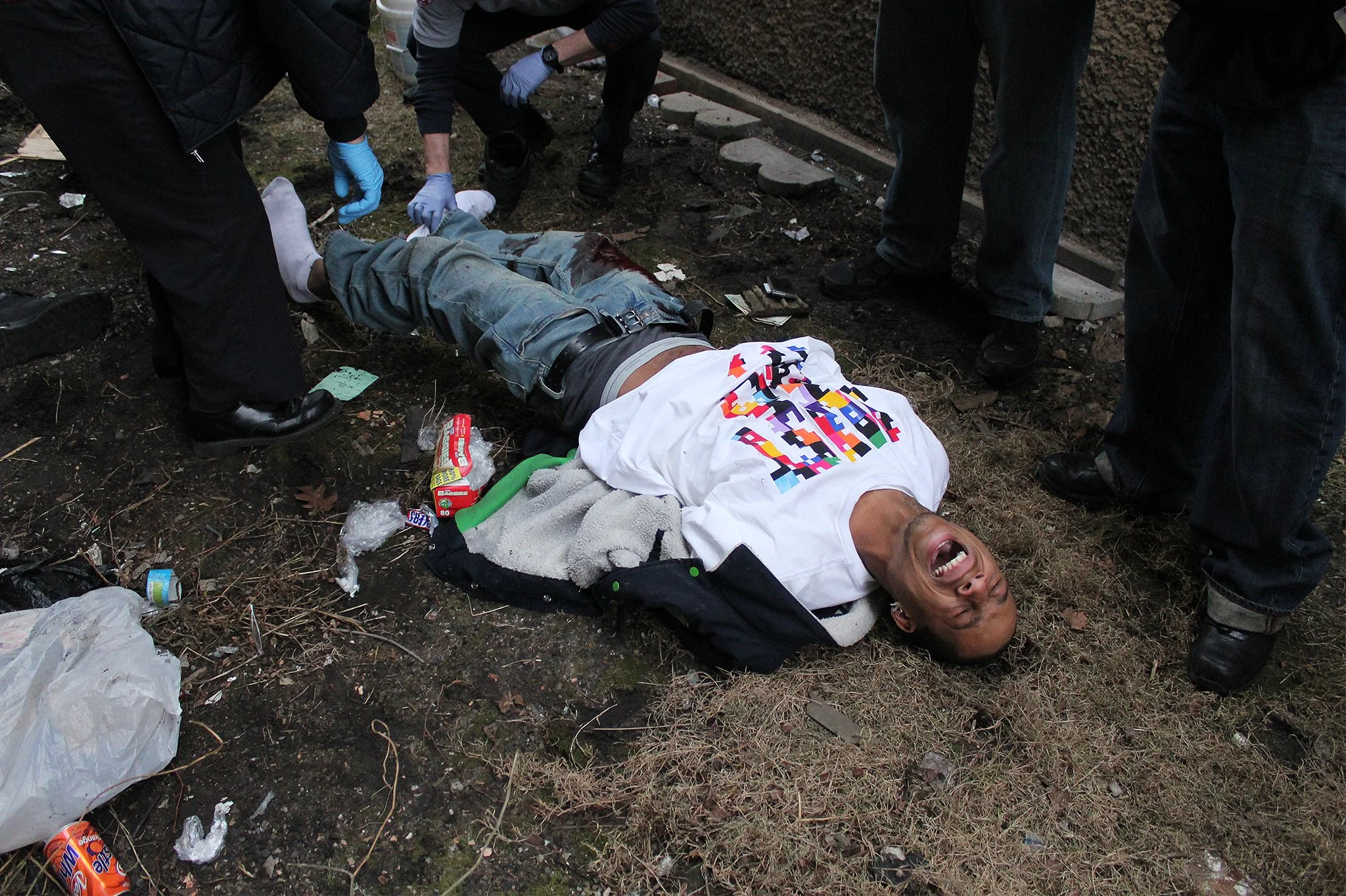 Paramedics examine the body of an injured man who was shot in the leg in the Woodlawn neighborhood on Chicago’s south side. The neighborhood is known as one of the worst areas in the U.S. in terms of high rates of violent crime.