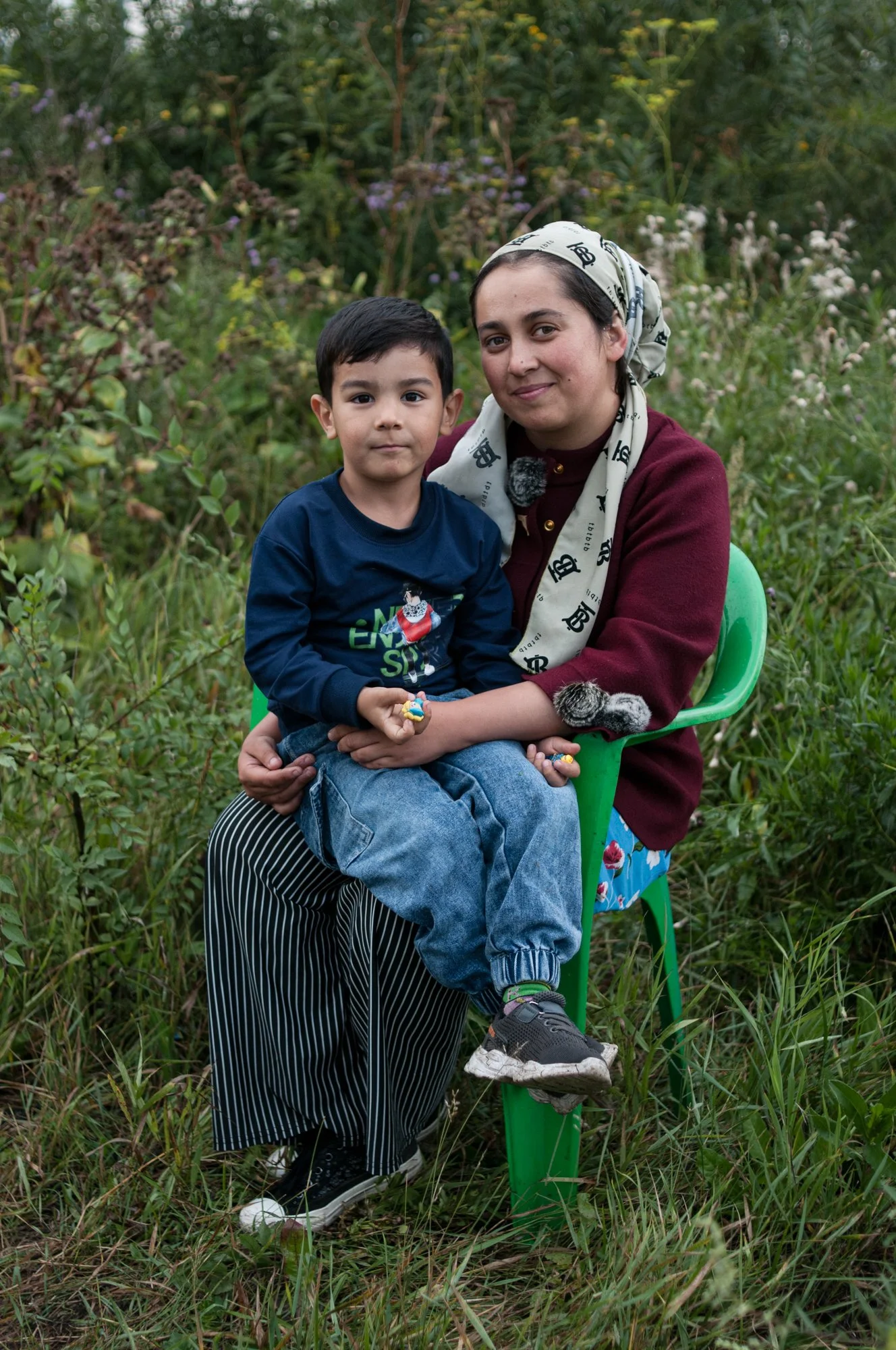 A migrant worker and her son from Central Asia sell kvas, a traditional Russian fermented non-alcoholic beverage, from a stylized soviet-looking cistern on a curb of a road in an industrial area of Novokuznetsk, Russia. Kvas was popular in the USSR a