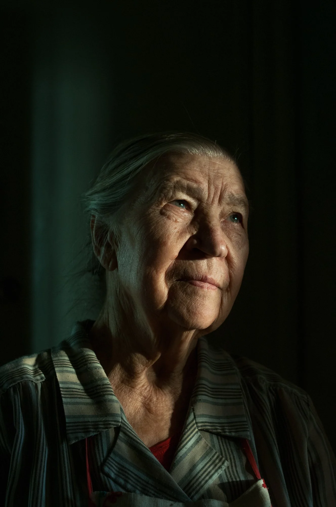 Grandma poses for a portrait in her apartment in Novokuznetsk, Russia.