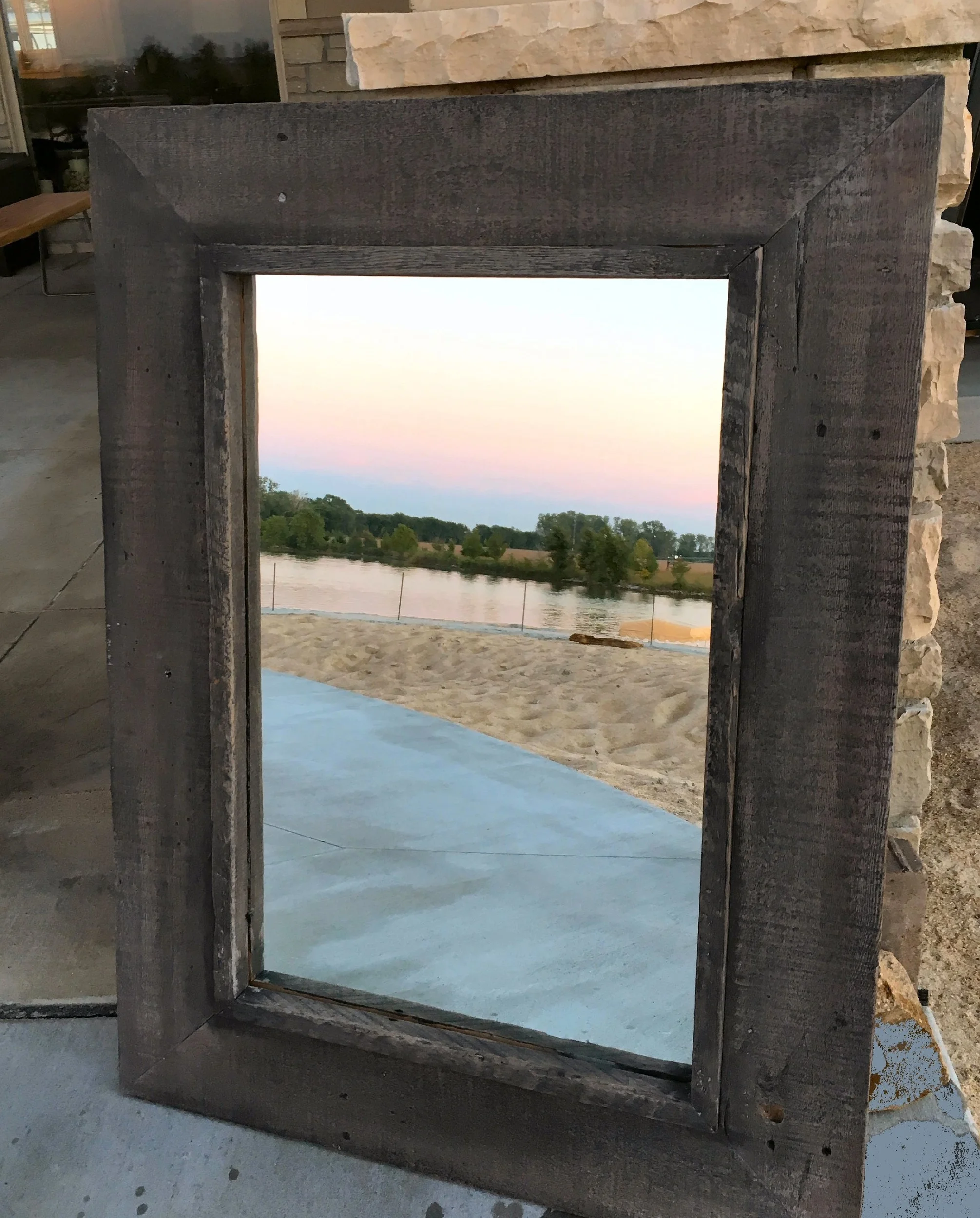   This one of a kind mirror is hand crafted using wood from a near century old prairie barn.&nbsp; The frame has been finished with gray and black old fashion Milk Paint.&nbsp; We include a brief history of the barn as well as a picture of the barn w