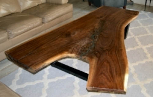 This amazing and unique Black Walnut live edge coffee table is guaranteed to be the focal point of any living room. The wood slab is highly figured with long, beautiful feathering running along the center with a pyrite mineral inlay. This mineral's metallic luster and pale brass-yellow hue give it a superficial resemblance to gold, hence the well-known nickname of fool's gold. The irregular walnut slab has raw edges and a fine polished surface, finished with natural oil. The base is made of 2" X 3" steel tubing, giving the table a modern industrial look. Finished build measures: 71" L x 23" to 53" W x 16" H, and the slab is up to 3" thick. ABP Works designs furniture pieces integrating wood’s organic characteristics with a clean, graceful, modernist aesthetic...$2300.00