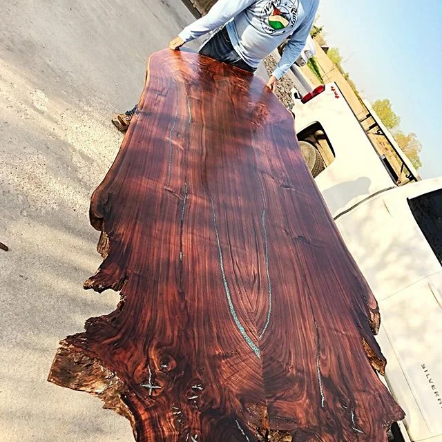 This customer is  picking up his custom live edge book matched Black Walnut hanging headboard we built.