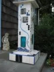 The "illumination pillar," fabricated of porcelain tiles, art glass, bisque masks and bits of jewelry by Stephen Albright and presented to his wife, Caroline, in Finding christmasville.