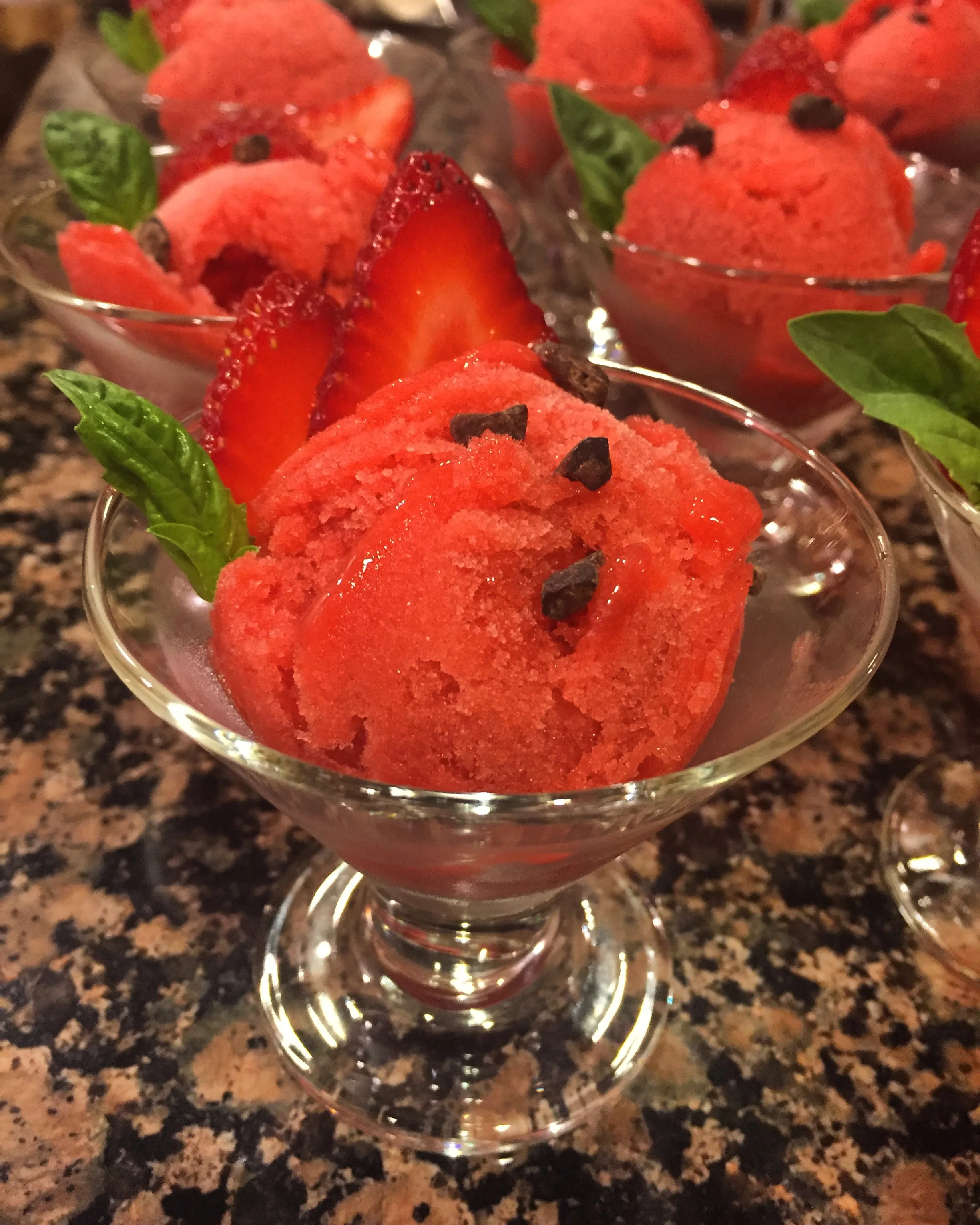Strawberry basil sorbet topped with sweet cacao nibs.