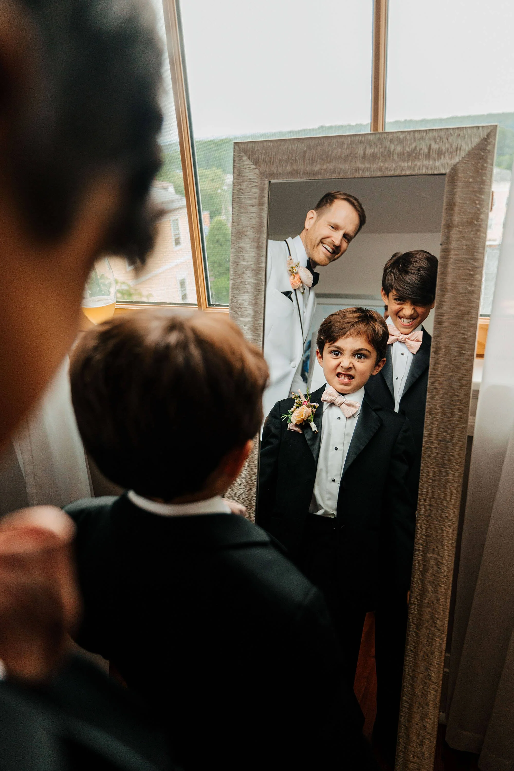 GAUPERphoto Rhode Island wedding photographer candid groom and ring bearers making faces in mirror, Varnums House East Greenwich top destination wedding photography