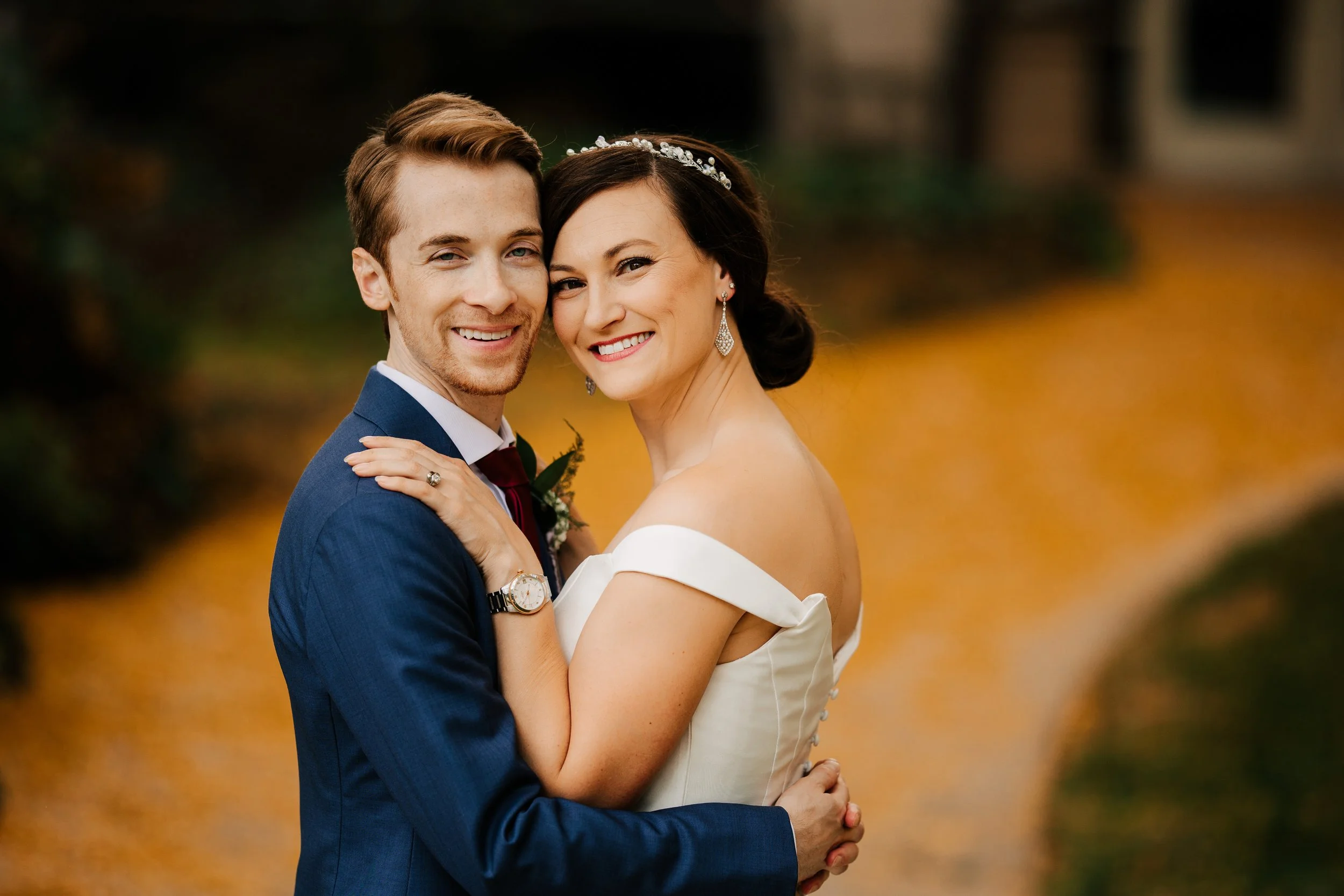Bride and groom sharing a romantic moment during wedding portraits at Timberlee Hills in Traverse City, Michigan