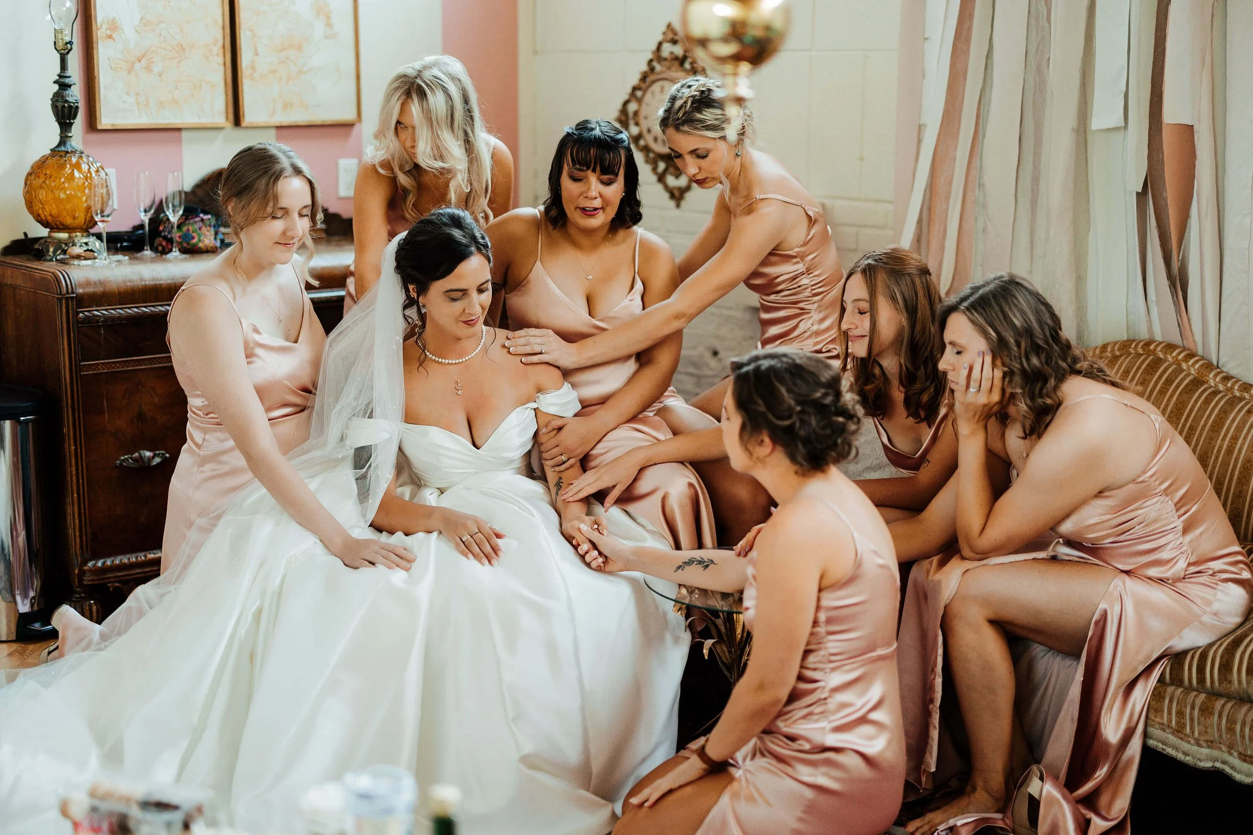 Top candid wedding photographer Grand Rapids Michigan bridesmaids comforting emotional bride getting ready, The Cheney Place