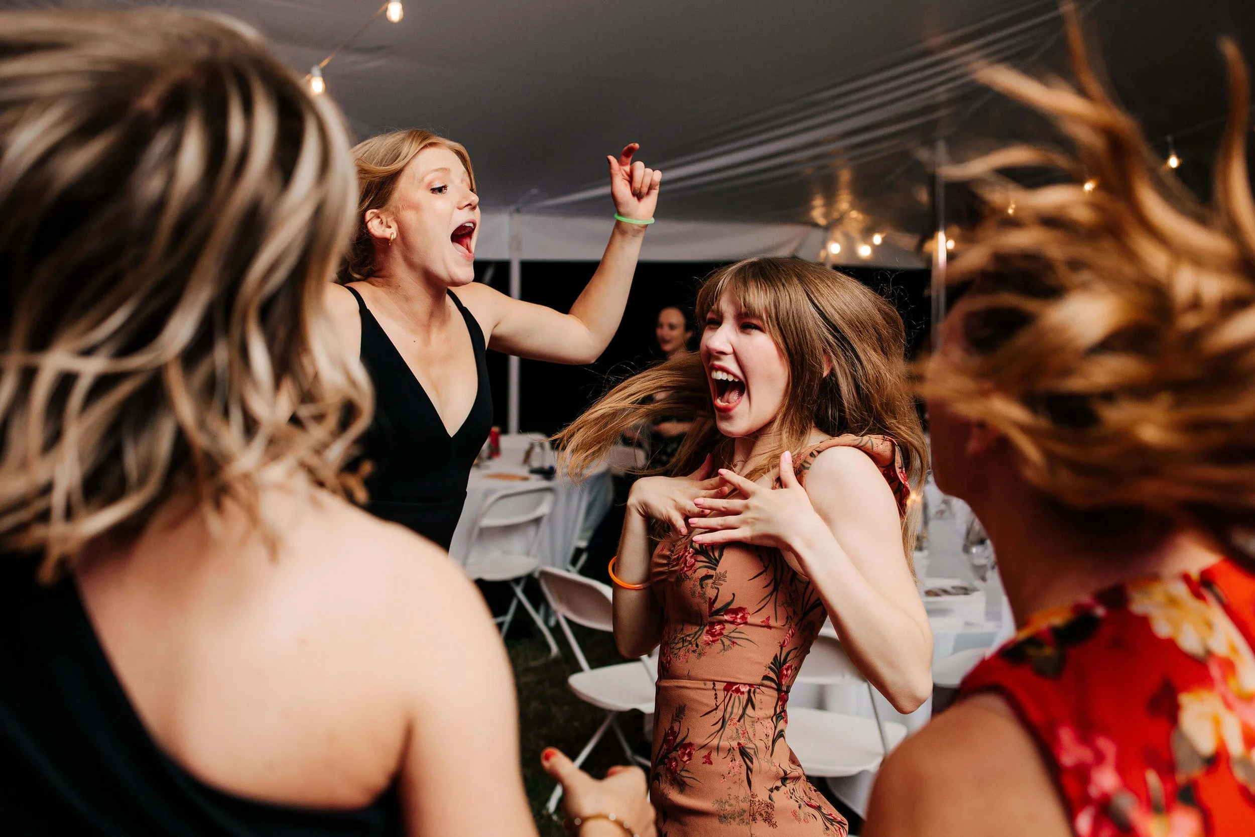 Bay Pointe Inn wedding photographer Shelbyville Michigan candid guests dancing at outdoor tented reception, best West Michigan wedding photography