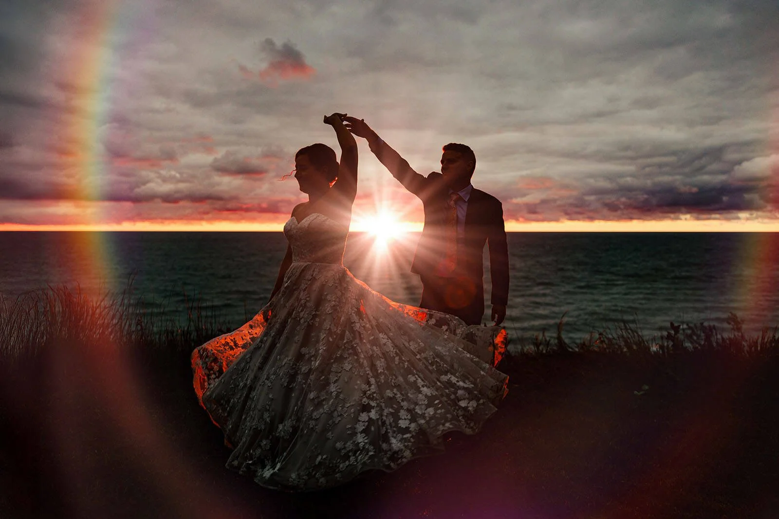 GAUPERphoto Ludington Michigan backyard wedding bride and groom silhouette dancing at Lake Michigan sunset with rainbow, top West Michigan luxury wedding photographer
