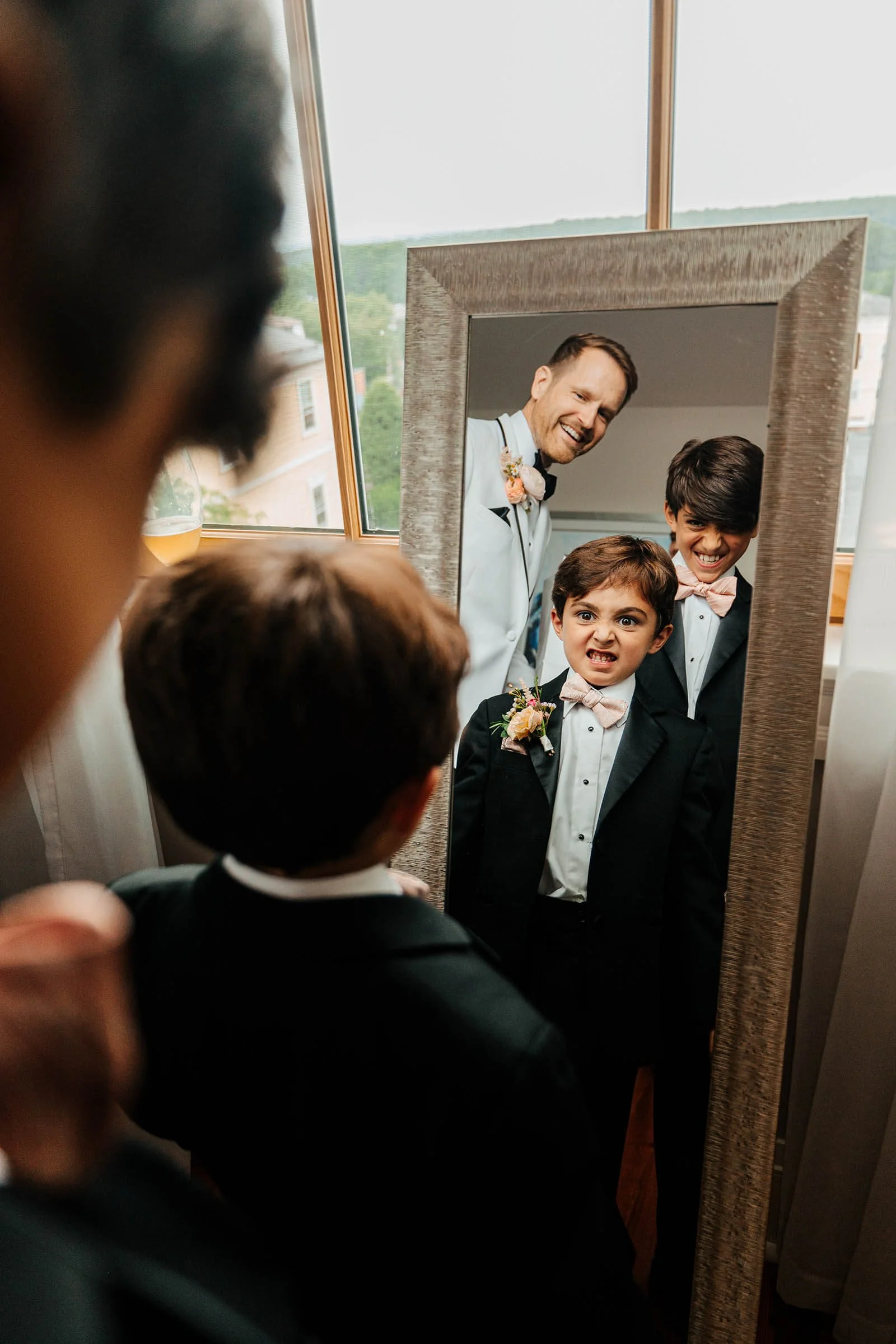 GAUPERphoto Rhode Island wedding photographer candid groom and ring bearers making faces in mirror, Varnums House East Greenwich top destination wedding photography