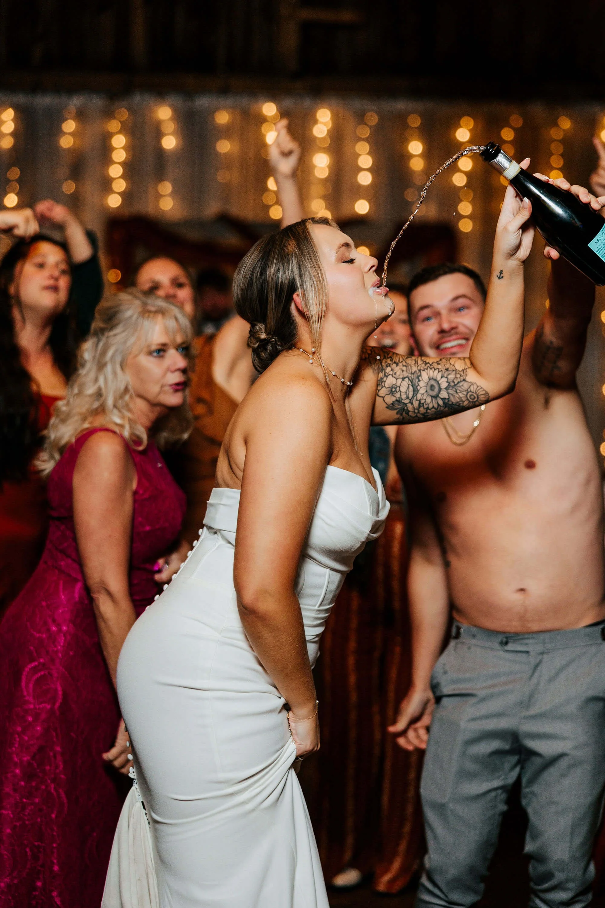 Jordan Valley Barn wedding photographer East Jordan Michigan candid bride champagne pour on dance floor, best Northern Michigan barn wedding photography
