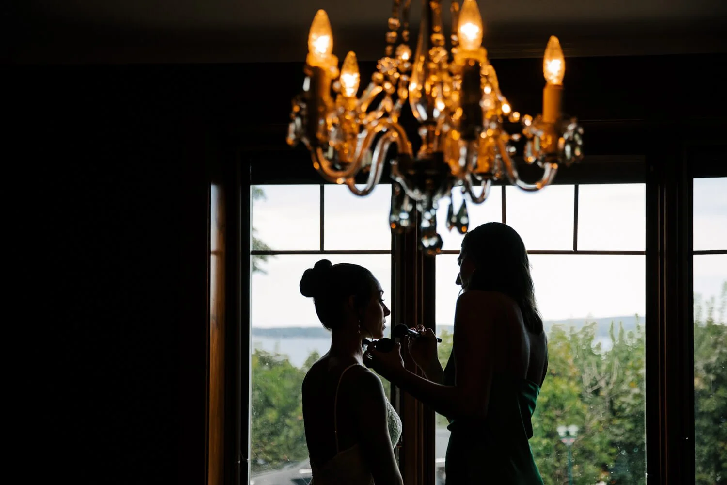 Groom laughing with groomsman during wedding celebration at the JW Marriott in downtown Grand Rapids, Michigan