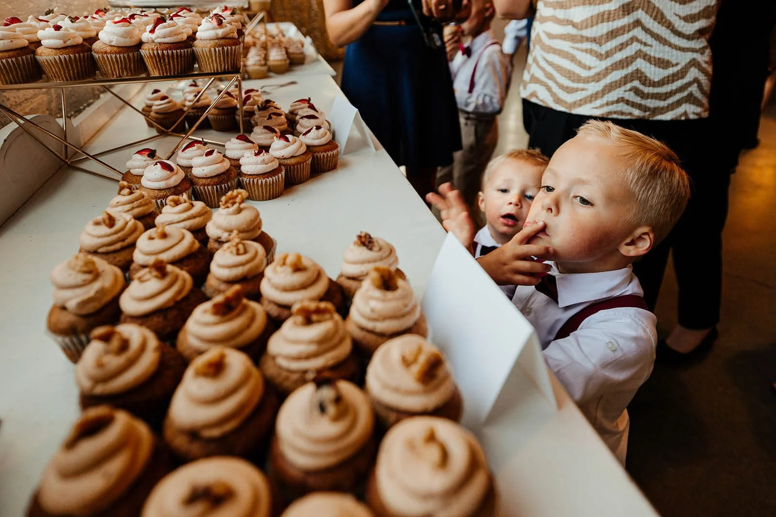 Grand Rapids candid wedding photographer unposed moment kids eyeing cupcake display at reception, The Cheney Place Michigan