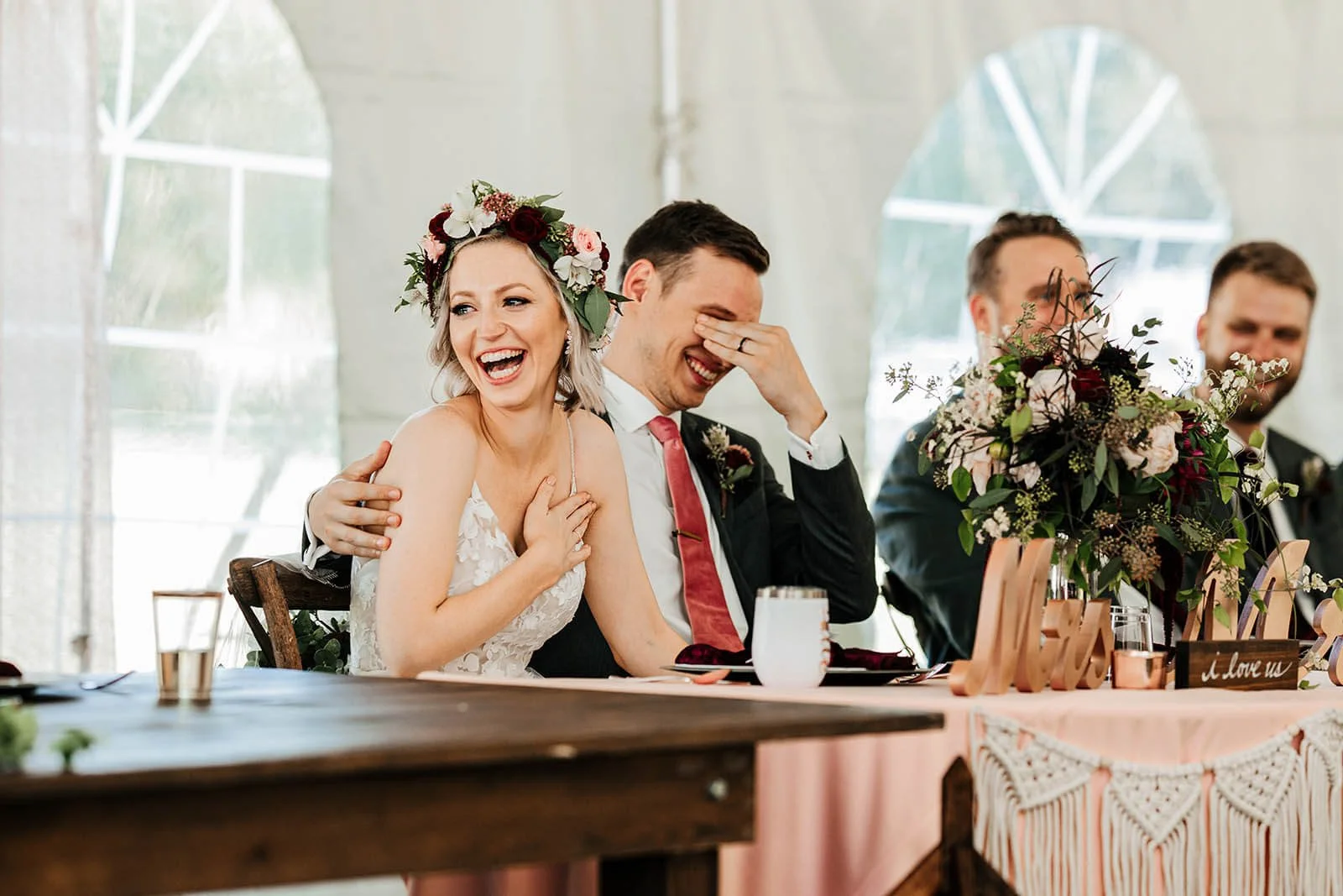 Editorial wedding photographer Indiana candid bride and groom laughing during toasts sweetheart table, top documentary outdoor tented reception