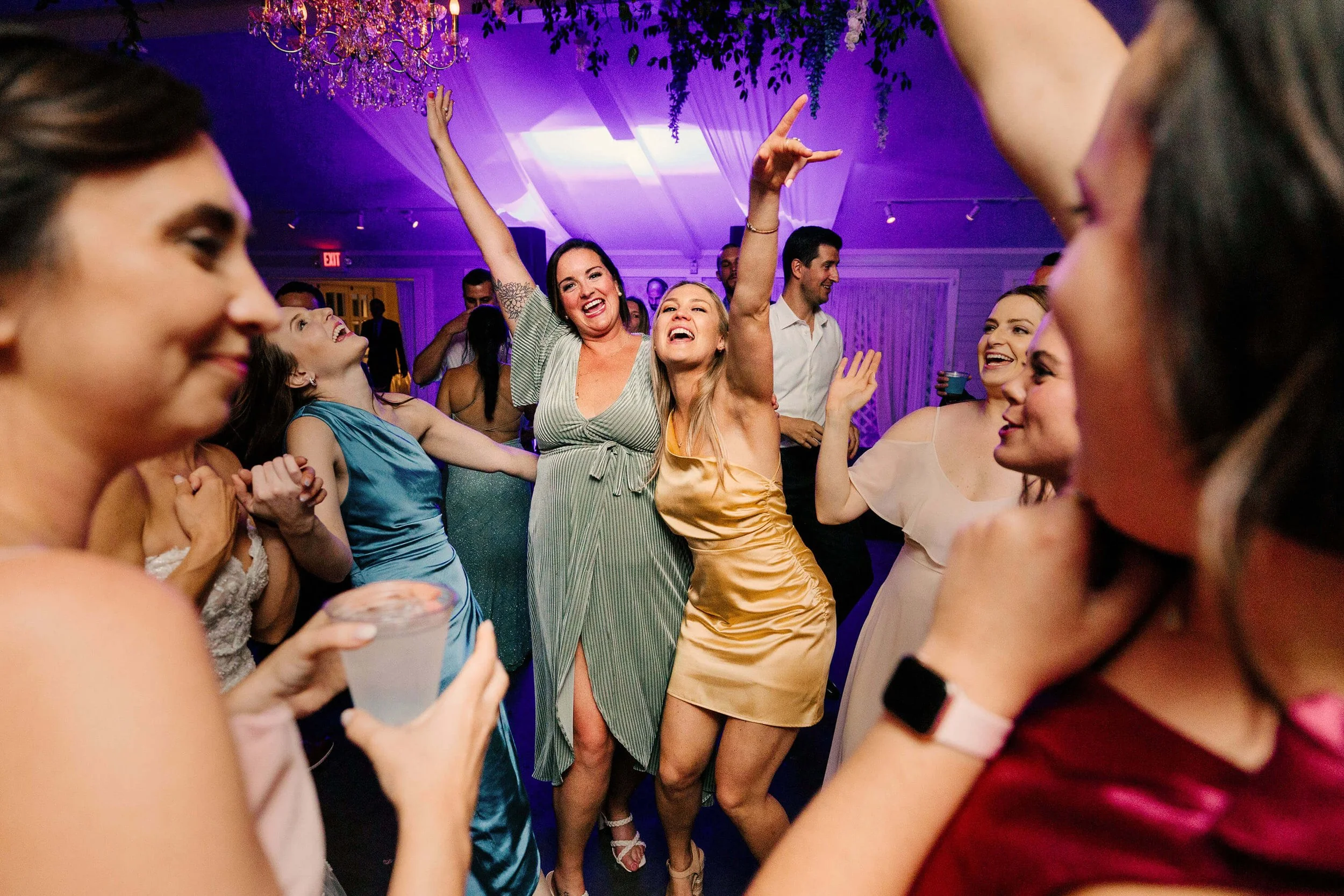 Castle Farms wedding photographer Charlevoix Michigan candid guests dancing under uplighting, best Northern Michigan luxury wedding photography