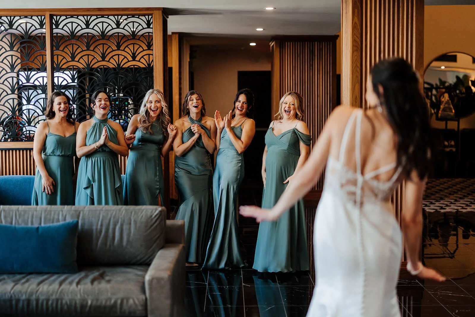 Elevate One Campus Martius wedding photographer downtown Detroit candid bridesmaids in teal dresses reacting to bride reveal, best luxury Detroit wedding photography GAUPERphoto